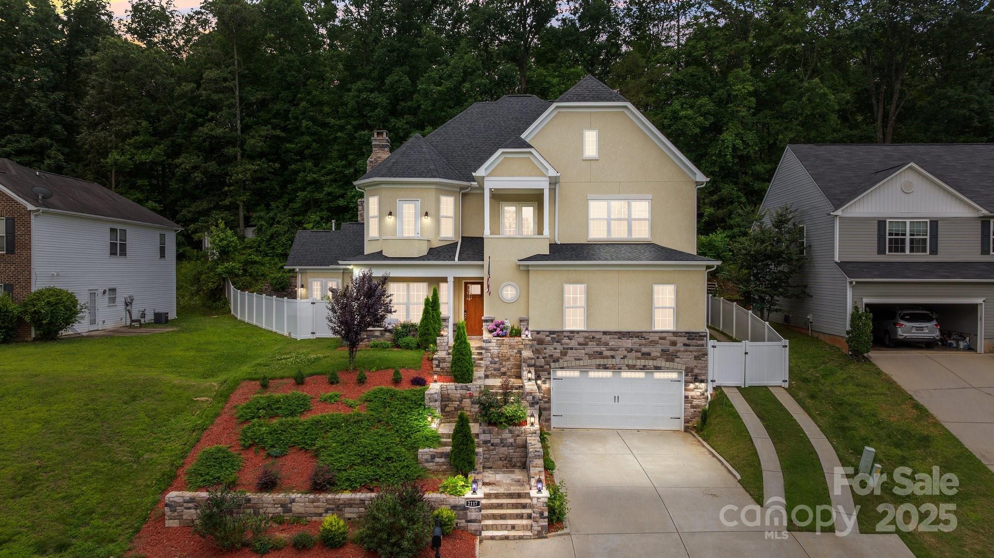 Well appointed custom built executive home. Elegant curb appeal. Easy access to Hwy 77 and 30-45 minute drive to Uptown Charlotte. Fort Mill location and excellent school assignments.  Designer features abound. Stately curb appeal. Seller was involved in all aspects of the building process and can provide video of stages while the home was being built. Solid, well built home with steel frame construction at the foundation. (see attached photos) Inside you'll find well appointed amenities with today's modern finishes. Function meets style with this rare showcase floor plan. Dramatic columned living area, stone fireplace and staircase sidewall. Abundance of natural lighting throughout the plan. Bay window living room with open concept  through main level. Spectacular kitchen, quartz finishes, farm sink, huge walk in pantry; all tastefully complete. Theater room on main level for at home entertainment. Full BR and bath on main level.   Private office/study at rear of plans main level. Custom tile, quartz and craftsman finishes throughout. Beautiful white oak flooring and heavy moldings. Luxurious primary bedroom retreat with walk in steam shower and bench seating, raised garden tub. Serene and relaxing area to unwind after a busy day! Secondary bathrooms with travertine tile, bench shower seating, frame-less glass shower enclosures and custom cabinet/fixtures, custom tile finishes. Bedrooms feature built in bench seating, wood flooring, private  baths. You'll be impressed with  the 330' Finished rear keeping room just off the kitchen with double French doors to rear. This room has an additional stacked stone  fireplace, sink and overhead draft system. The square footage for this area not included in total heated square footage.  Lower level basement features an additional bedroom that is heated and finished. Plenty of additional space for incidentals at the lower level with drive up oversized 2 car garage and additional storage room. Walk out covered front porch at upper level with commanding views, additional walk out open landings to outside from secondary bedrooms- Perfect for that prom or wedding photo. Calm and welcoming covered front porch with sitting area.  Travertine tile and in laid stone steps & sidewalls create a commanding entry. This home is an architectural marvel! New 6' privacy vinyl fencing surround. Additional new construction build photos available upon request. Per seller: gas connection at kitchen. Be sure to check out the Matterport interactive virtual tour link.  https://listings.lighthousevisuals.com/sites/lkqwqrp/unbranded.