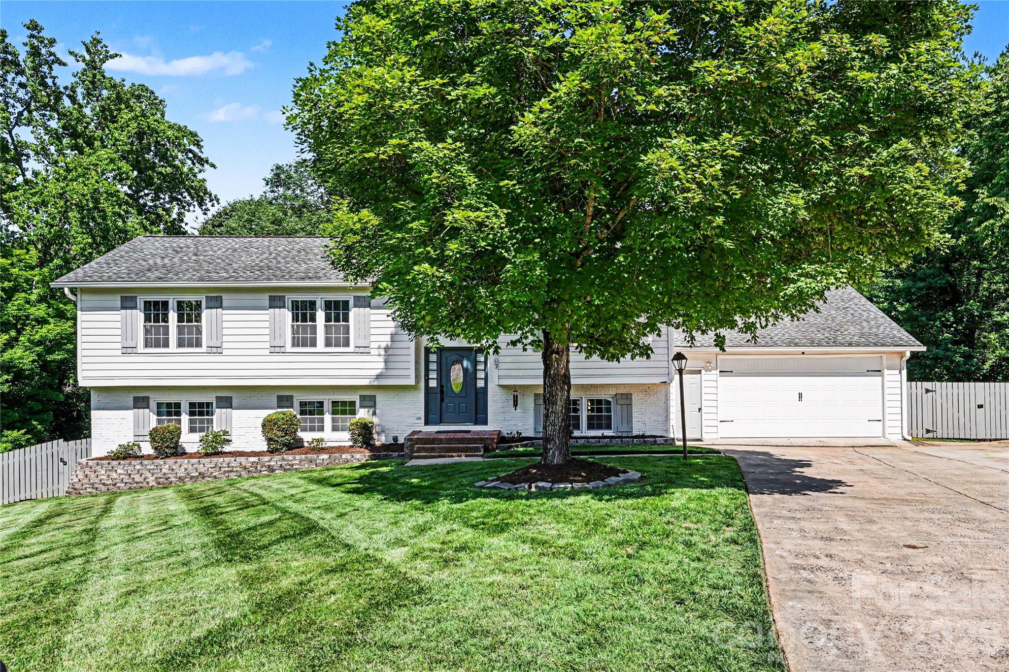 Priced below nearby competition and tucked into a quiet cul-de-sac in South Charlotte’s Heritage Woods area, this modernized home delivers the space, updates, and garage setup buyers are hoping to find — but rarely do. The open floor plan features hardwoods throughout the main floor, custom kitchen cabinetry, granite countertops, and a refreshed interior designed for comfortable everyday living and easy entertaining.

The lower-level primary suite offers extra-large space and privacy, complete with a tile shower, glass door, and direct private entry to the deck and hot tub area. It is basically your own little escape without having to pack a bag.

The main level also features a bedroom with its own renovated full bathroom, creating an ideal setup for guests, multigenerational living, or anyone who appreciates privacy and not sharing a bathroom. Outdoor living is another major highlight with a fully fenced large backyard, updated back deck in 2026, and a private double-deck setup perfect for relaxing or entertaining.

One of the few homes in the subdivision with a 4-car garage, this property also offers the storage, hobby space, or workshop potential that is hard to find in this area. Conveniently located near Providence Rd, Sardis Rd, SouthPark, Cotswold, Matthews, The Arboretum, Waverly, Promenade on Providence, and nearby greenway access, this home offers a rare combination of privacy, updates, garage space, and South Charlotte convenience.