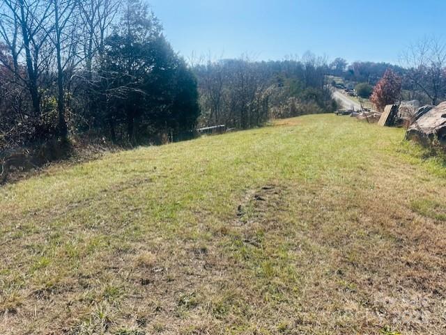 Nestled in the heart of the majestic Blue Ridge foothills just outside of downtown Marshall, this remarkable land offering on Bend View Drive is a rare opportunity to own your own slice of Western North Carolina heaven. Picture morning mist rising across the valleys, long-range ridgeline views framed by towering evergreens, and the gentle soundtrack of woodland birds and rustling leaves.