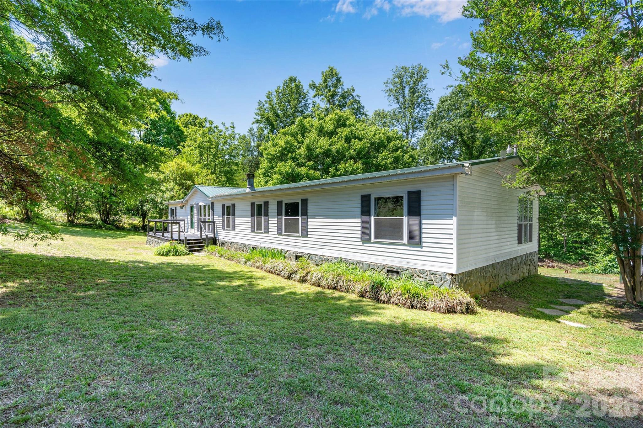 WHOA, Fresh new price AND seller offering $5,000 towards buyers closing cost. This one is priced to sell!!!! 2.6 acres, right at 2,000 sq ft, 3 bedrooms with a bonus/flex room, and a 2-bay metal garage!!! If you are looking for space on a budget THIS IS IT!  There is nothing else in Denver with 2 + acres even close to this price point. This home has been partially renovated with both bathrooms completed, new flooring and lots of upgrades/replacements to the home. New metal roof in 2014, new hot water heater in 2024, new well tank in 2024, household water filtration system installed, and the decks have been refreshed and renewed. The owner's suite is huge and is situated on its own side of the house. The owner's closet is the size of a small room, and the ensuite bathroom... so very cute with its rustic renovation. Like spending time outdoors, the back deck is sure to bring pleasant times either enjoying your morning coffee or grilling out in the evenings. The space here is plentiful and the layout of the home lives comfortable, you truly must tour to appreciate. If you have large work vehicles, there is plenty of room here to park and store them. While there have been some renovations completed there is still TLC needed in areas that you could do yourself to build sweat equity.  Wonderful location, great schools, close to everything... dining, grocery, gas, etc..  Don't wait tour today!