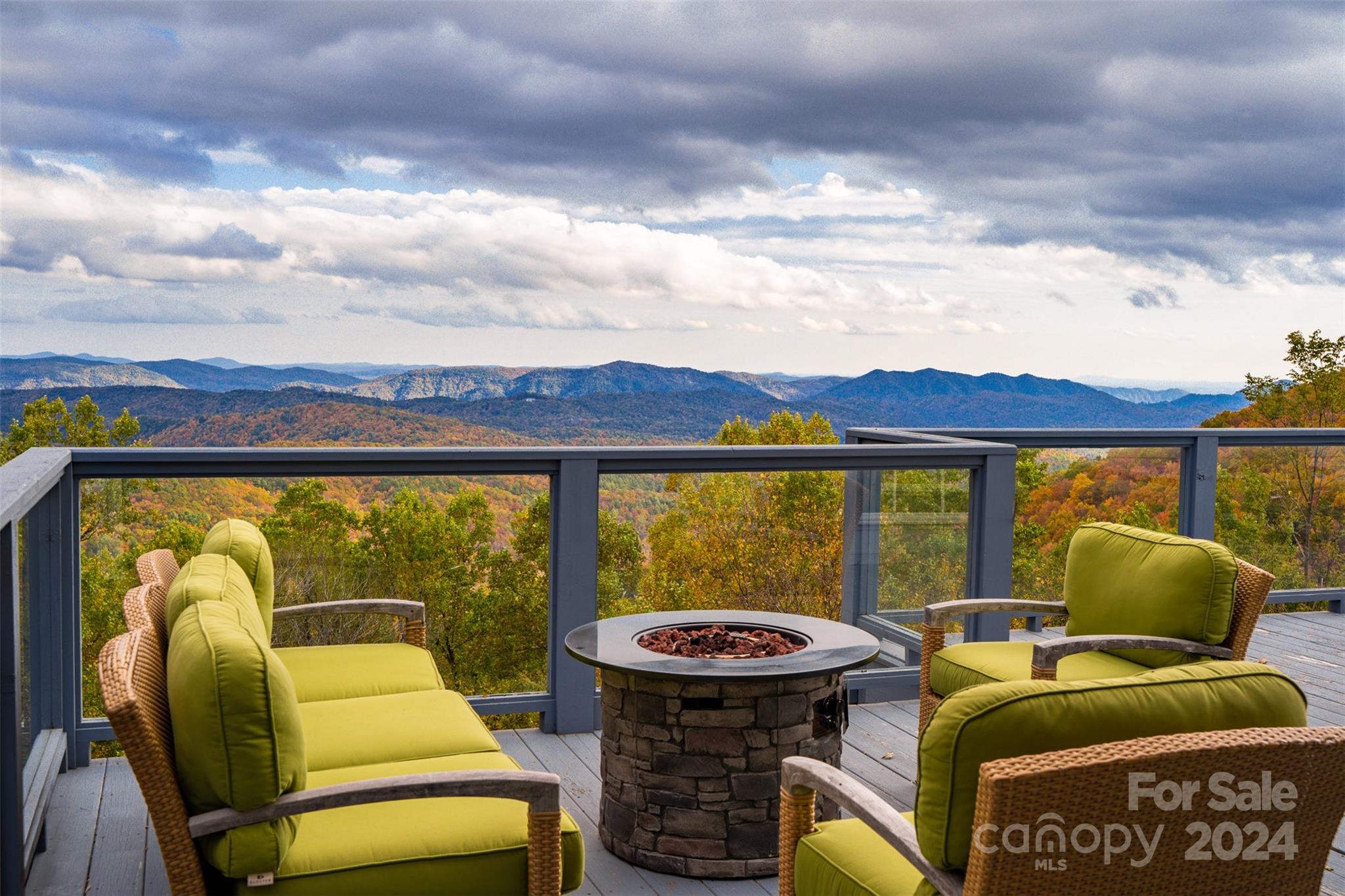 The perfect retreat, full-time residence, or investment property w/ long-range, layered Gorge & Blue Ridge Mtn views resting on 11.3+ acres of wooded privacy. This 3BR 4.5BA home (w/ bonus rooms/spaces) offers a quiet setting & central location to Boone (20 min), Blowing Rock (15 min), & all the High Country has to offer! Short-term rentals allowed=vacation rental potential! The spacious great room features window-lined walls for taking in the views & gas fireplace & wet bar, & is adjacent to the dining area & kitchen w/ fireplace, granite counters, & kitchen island. Enjoy the mountain views (w/ Sunrise views to the East) from the large deck or large, covered, wrap-around front porch. Main level also features addt'l living room/den & bonus room/office currently set up as a BR, half bath, & entrance foyer. On the second level, find a landing area/reading nook, three BR/BA suites incl. the primary suite w/ gas fireplace, bonus room currently used as a BR, additional full bath, & laundry.