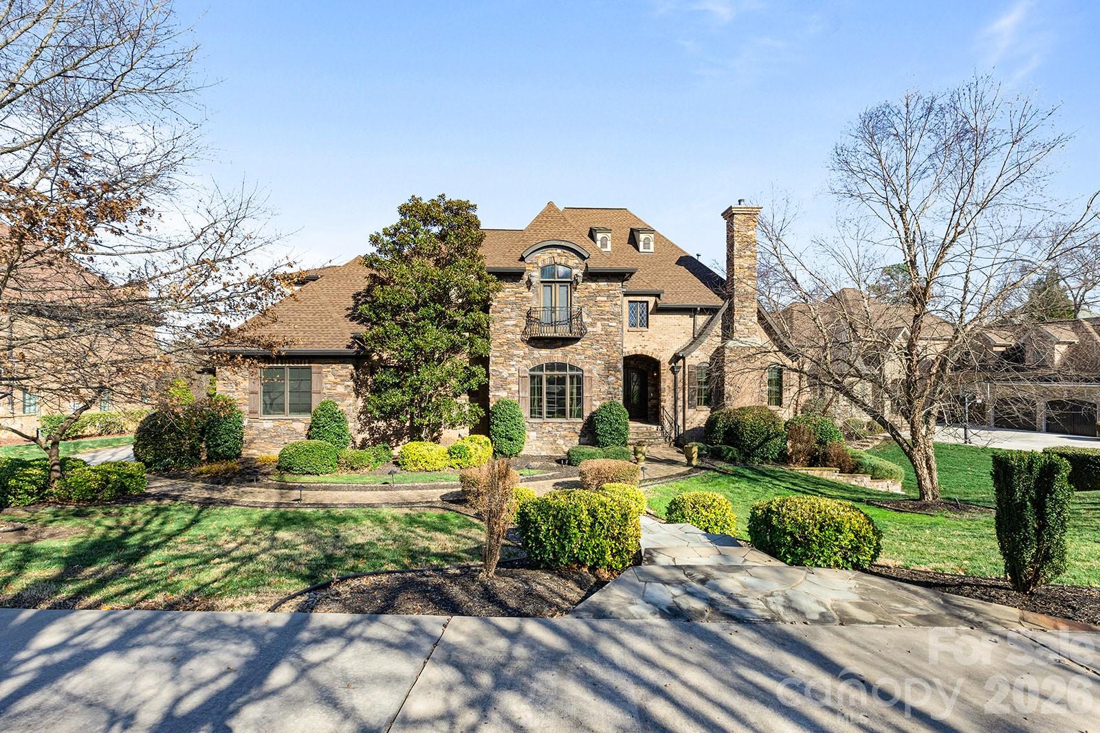 Luxury meets location in the heart of Providence Downs South!  An exceptional residence where architectural artistry meets everyday luxury living. From the moment you arrive, custom molding, decorative ironwork, and meticulous architectural millwork reflect the level of craftsmanship found throughout this stunning 9,000 square foot home. Soaring ceilings with an abundance of glass for natural light, designer lighting, and rich hardwoods set a beautiful tone across the main level, while wood-accented cedar ceilings and extensive stonework add warmth and character to every space. The chef’s kitchen is built for both cooking and entertaining, featuring a 48” Thermador six-burner gas range, custom cabinetry, dual dishwashers, a wet bar, and designer finishes throughout!  A main-level home office with custom integrated bookcases adds great functionality, while gas fireplaces throughout the home create a warm and welcoming atmosphere in every season. The primary suite offers a true retreat, complete with an oversized walk-through shower with dual rain heads and two additional shower heads, and beautiful travertine tile throughout. A dedicated washer and dryer hookup within the en-suite walk-in closet adds a practical touch that sets this home apart. The fully finished basement with 12' ceilings is made for entertaining and everyday enjoyment, and feels like an additional living space. A four-person sauna with integrated lighting and speakers, a home theater with projection and blackout shades, a home gym with rubber flooring, a second home office, a full kitchen, and a private guest suite with en-suite bath and walk-in closet give this level a versatility that is hard to match. Bespoke backlit artwork frames the theater entry and is one of many thoughtful design details found throughout. Outside, the backyard is a true getaway. A heated saltwater guinite pool with Pebble Tec finish, a tanning ledge, and custom travertine hardscape create an outdoor space that is both beautiful and functional; private and serene. A poolside arbor provides shade and a place to relax, while the covered patio with wooden ceiling and fans connects directly to the basement and makes indoor-outdoor living easy. The outdoor kitchen includes a Coyote built-in grill, Coyote beverage refrigerator, and generous hidden storage behind the cabana. The main level screened porch has its own outdoor kitchen with a 42” gas grill, sink, perfect for outdoor dining and entertaining year round. The three-car garage offers elevated ceiling height to accommodate a car lift. A home that has been thoughtfully built and carefully finished at every level.  Top-rated Marvin schools, and just minutes from The Bowl in Ballantyne, but tucked away by the gates of PDS!