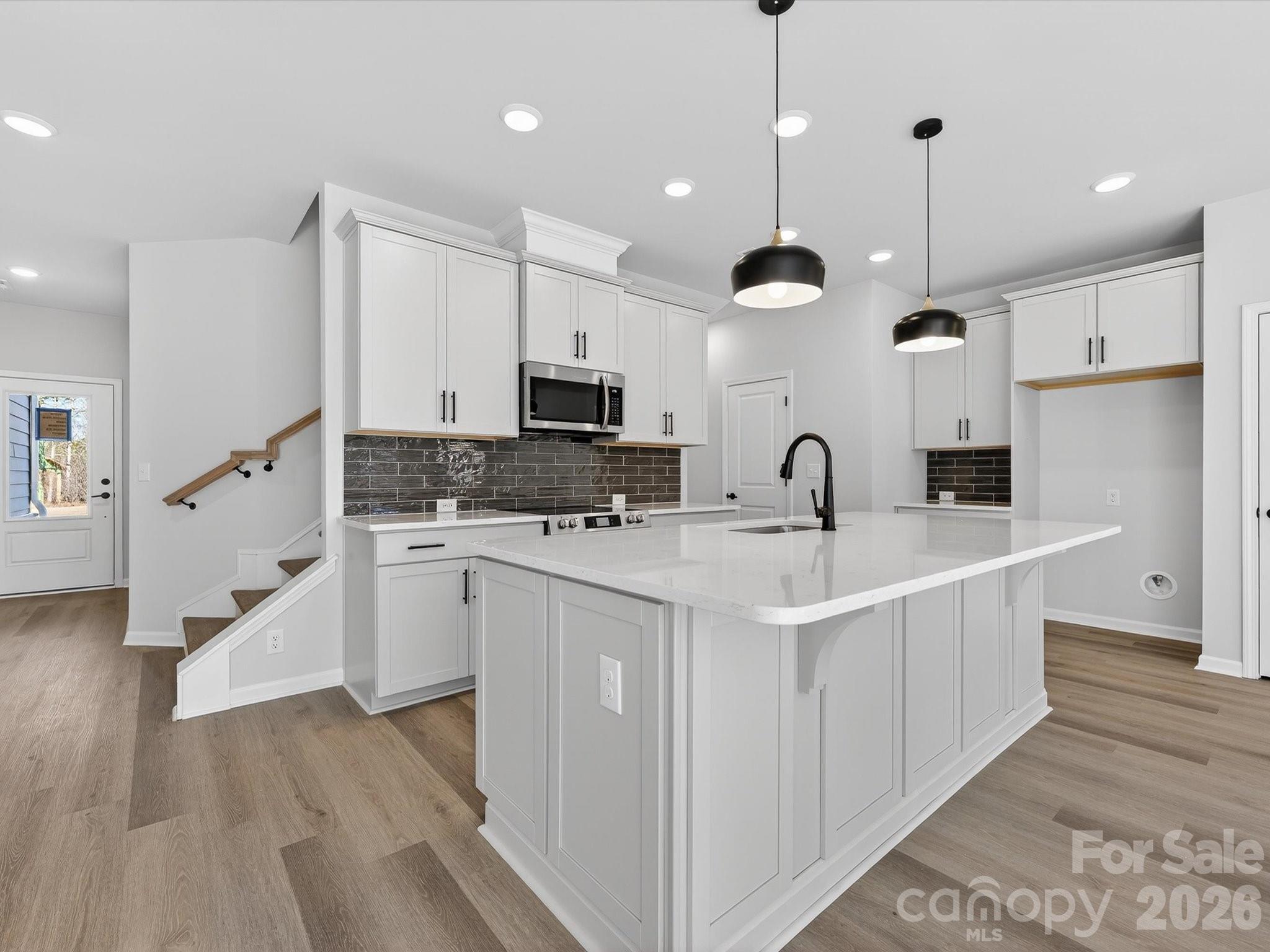 Discover the ease of luxury low-maintenance living in this brand-new Thornhurst II townhome, conveniently located just minutes from Ballantyne, Waverly, and the charming shops and restaurants of historic downtown Waxhaw.

Filled with natural light, the open-concept living area is highlighted by three large picture windows overlooking a private wooded backyard. The designer kitchen features 42” Frost-colored soft-close cabinetry, sleek quartz countertops, a spacious island open to the family room, Frigidaire stainless steel appliances, an exterior-vented range hood, and a pantry with solid shelving.

The main level showcases durable LVP flooring throughout, along with composite stair treads leading to the second floor. Upstairs, unwind in the luxurious Owner’s Retreat featuring a tray ceiling, oversized walk-in closet, and three large windows that create a bright, airy feel. The spa-inspired primary bath offers tiled flooring, a large tiled walk-in shower with bench seating, dual vanities with quartz countertops and soft-close cabinetry, a linen closet, and a private water closet.

The second floor also includes two spacious secondary bedrooms, a full hall bath, and a thoughtfully designed laundry room with tiled flooring and a convenient folding table.

Enjoy peaceful mornings or relaxing evenings on the covered porch overlooking the wooded backyard. A side-by-side two-car garage and full driveway provide ample parking for both homeowners and guests.

With low taxes, low-maintenance living, and the feel of a single-family home, this townhome offers the perfect blend of comfort, convenience, and style. Ask about special low-interest rate opportunities!