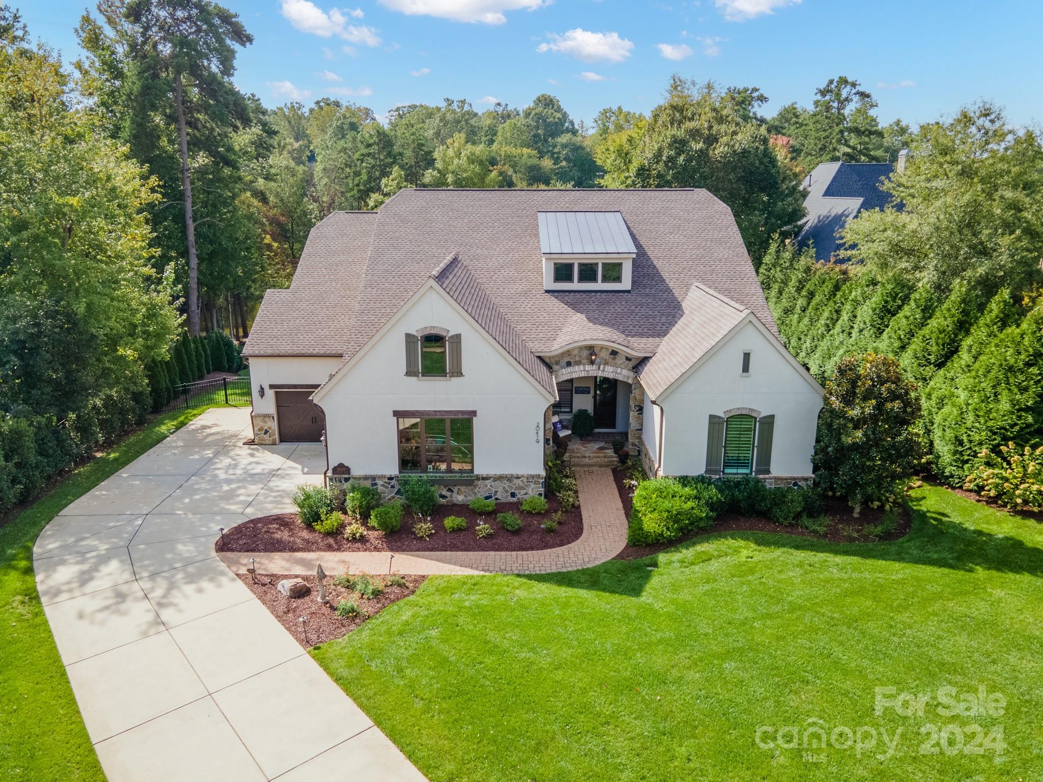 VACATION EVERYDAY! Beautiful Waterfront in quiet cove. Dredged/deeper water. Stunning Views, Watch wildlife, Private Dock w/lift, Swim from private Beach, Bathe in the Sun on large sundeck, Wood Burning Firepit by lake, Gas Firepit on over size patio, Stone Pellet Grill w/Gas burner, Pizza Station, This spacious Open Floorplan was built to entertain, Dual Gas Stone Fireplaces in great room and on large covered patio, Stone benches, Sliding Double Doors opens the home up to the outside. Hard Stucco/French Country, 1.30 Acres, Lush Landscapes, Fenced yard, Covered Front Porch w/Flagstone, Office w/Coffered Ceiling & Barn Door, 2 Story Great Room, Master on Main with Large Steam Shower, Dual Sinks, Custom Walk in Closet with Access to Laundry Room. Kitchen features Lg Island w/bar seating for 8, 6 Burner Gas Stove, Double Oven, SS Appliances, Dining Room with tons of cabinets, 2nd Master Up with walk in closet, Oversized Game/Media Room, Movie Projector. 3 Car Garage w/built in Cabinets.