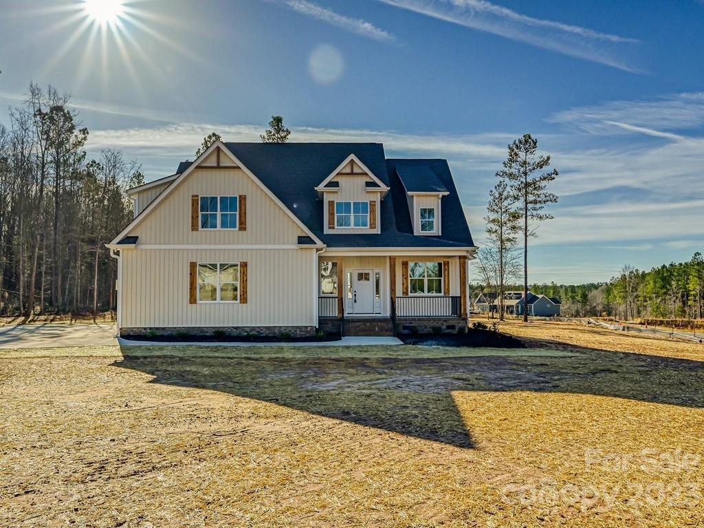 Located in Sanders Landing of Clover, SC and situated on an expansive 1.3+ acre corner lot, this 4-bedroom--plus an office--home is an absolute stunner! The front door leads into an impressive, 2-story foyer w/ gleaming hardwoods throughout the main. The Primary suite is down & features vaulted ceilings, 2 spacious walk-in closets, & a spa-like bathroom w/ free-standing tub. The family room's soaring ceilings are open to the 2nd floor above & gets incredible natural light. The Chef's kitchen includes a gas range, pot filler, large granite island, quartz counters on perimeter cabinets, & huge walk-in pantry. Prepare to be wow'ed by the laundry room's quartz counters & abundant cabinetry! R-15 wall insulation, R-38 blown cellulose in attic, quiet zone insulation in primary suite interior walls, Ultra low E windows, & Rinnai tankless gas water heater all add to the efficiency of this home! Cat 6 drops to all bedrooms, living room, office & back porch.
