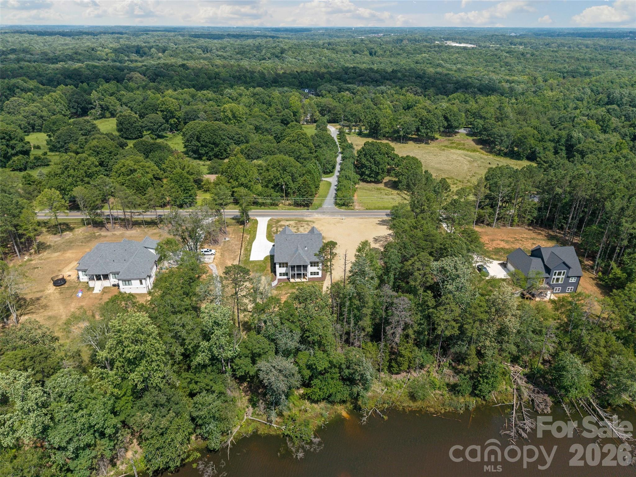 Welcome to this stunning CUSTOM new construction home. Wonderful location- close to Charlotte, Belmont, Lake Wylie. No HOA and in Clover School District!   Stunning stone fireplace, open floor plan with primary and office on main, crown molding throughout.  Gourmet kitchen features top appliances, beautiful countertops, custom cabinets, walk-in pantry with wood shelving and extra cabinets.  Sit and relax on the screened in back porch overlooking the pond, great for entertaining. 4 bedroom, 3 1/2 bath, bonus room, office, and roughed in basement. No detail has been left out, it's a must see!