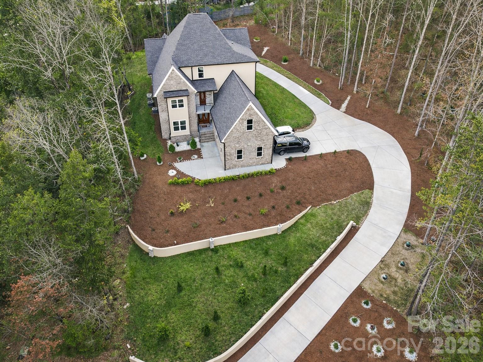 Build on one acre of land, this lovely house is surrounded by the beauty of nature and a breath-taking landscape. In the back of the house, a brand new pool can be seen next to a wide, long , elegant deck, and new exterior kitchen. 
In addition to this, there is plenty of parking space to fit up 8 individual cars. When first entering of  the inside of the  house, the modern contemporary style shines through the enchanting designs, and decor, of the great room.
Upon entering the first floor, you are mesmerized by the two by four porcelain title flooring, that can host a large living area, and recreational area. In contrast, the second floor is installed with elegant hardwood floor that can be seen throughout most of the house, connecting the great room, living area and beautiful kitchen carrying both double pantry , a double oven and flat top stove. All of this is in an open plan conservatory set up. creating a seamless living space. Additionally a massive guest and primary bedroom are available, with an equally matching large closet, and gym area, both possessing their own full bathrooms. There is also a laundry area towards the back of the main floor and a balcony located near to the kitchen that allows a incredible view. When walking up to the upper floor, another living area can be seen near an impressive primary bedroom, which have great privacy from the other bedroom and office. Each room, of course, have  their own full bathroom as well. Things like a high quality finished, custom details, and fourteen high ceiling of the grand aesthetic of the house. The beautiful secluded neighborhood host only thirteen houses total, with once acre per  house, with access to 10 acres of a path full view of nature, the location of the house is also near to both Concord Mills and Carolina Mall, and more than twenty seven restaurants. In the end, with everything it has to offer, this have can be definitely be your dream home.