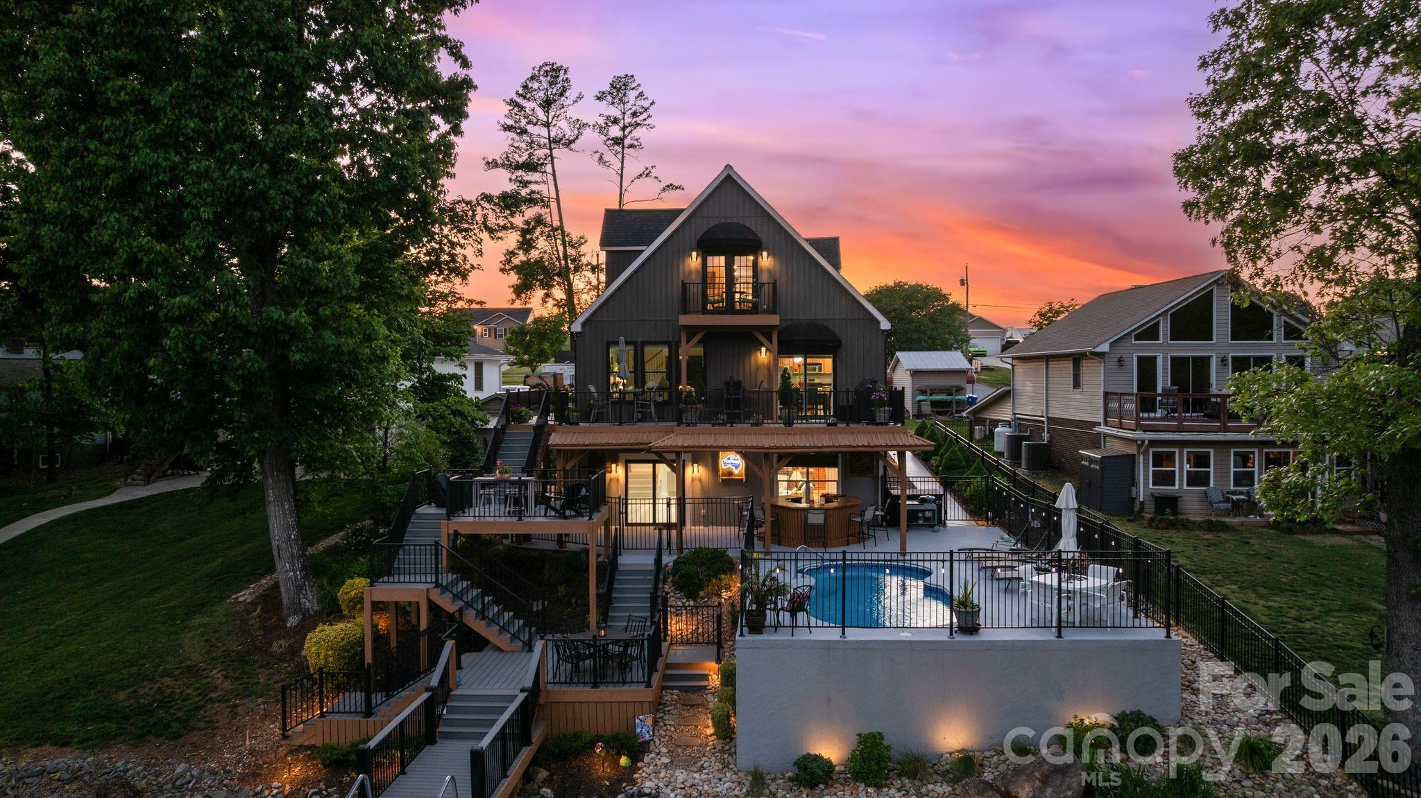 This ENTIRE High Rock Lake waterfront property is PRISTINE & IMMACULATE! MAJOR RENOVATIONS to include low maintenance outdoor materials! NEW LVP flooring, updated appliances, & custom blinds! Multiple decks! FUN at every turn! MEGA kitchen island! Relax by your indoor or outdoor bar and play in your saltwater pool w/ updated pump and enjoy custom landscape lighting at night! The NEWER stationary dock w/ U-shaped floater and heavy-duty lift (2023) make lake access easy! The spa-like primary bath features a large walk-in shower and oversized closet. ENTERTAINER'S DREAM, walk out basement w/ mega bar, pool table, living and multiple TV spaces. MORE MAJOR UPDATES - siding, windows, doors, gutters, driveway, heat pumps, water heater & MORE. Pier permit $100/yr + $175 transfer fee. 2026 tax value shown; 2025 tax rate listed, 2026 rate TBD. Forming sand bar at the mouth of Swearing Creek w/ red/green channel markers. Optional $85 yr - access to boat ramp. Preapproved buyers are welcome!