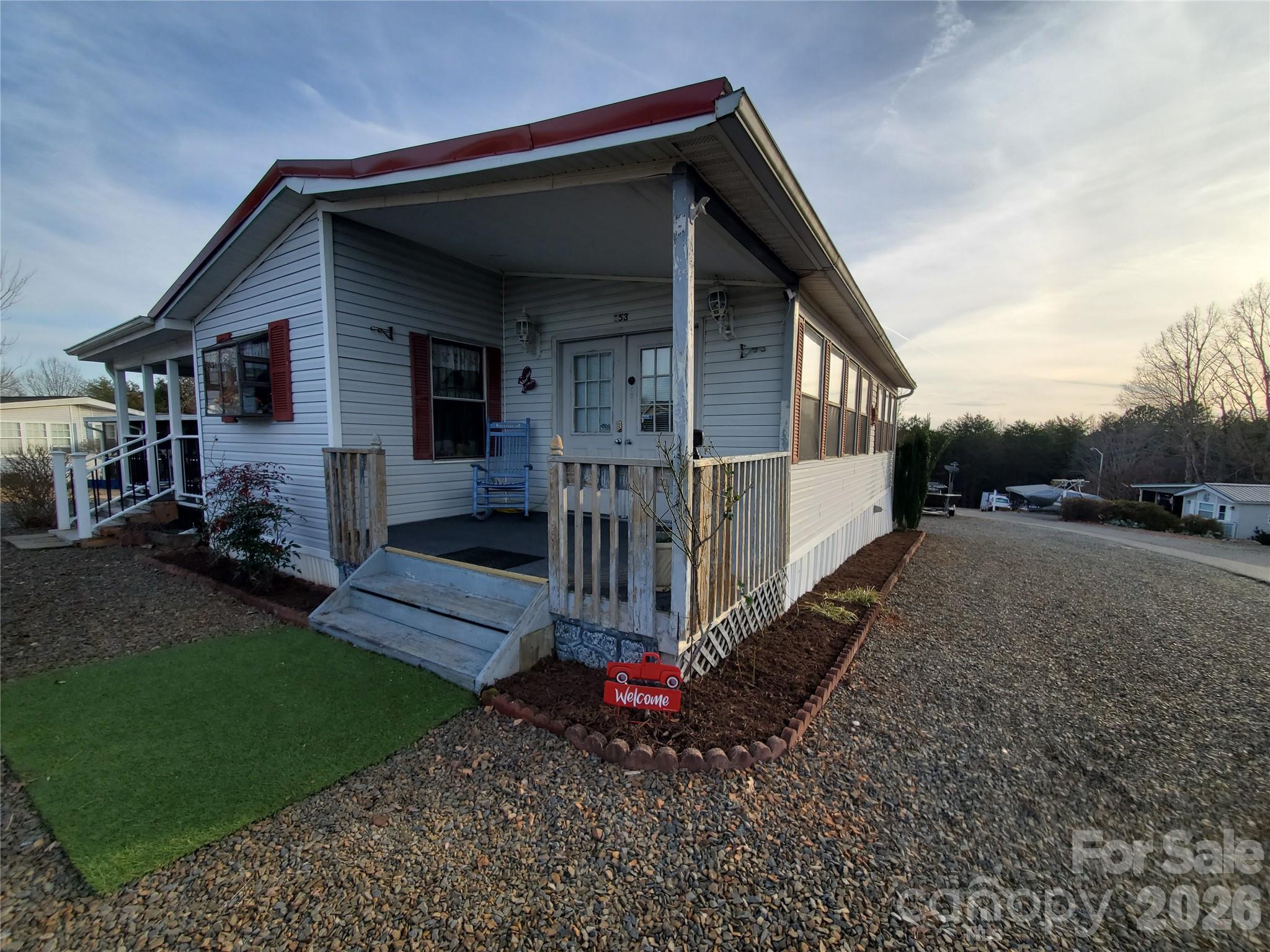 One family owner on a corner lot with this charming 1990 Park Model home with stick built addition that was added prior to owners move in. Gated community at Badin Shores Resort. 2 beds, 1 bath home offers a spacious 12x26 covered deck added in 2022 perfect for entertaining. Metal roof in 2016. HVAC replaced in 2020. Stove, refrigerator and stackable washer & dryer remain. Perfect for full time living or a relaxing getaway. So many amenities including a pool, lake access, fishing pier (must have fishing license to fish on pier),bb courts with pickle ball lines, clubhouse, RC Track, putt-putt, walking trails, horse shoe pits, playgrounds, basketball courts, Joeys Restaurant and boat launch, beach area and church. 2x10 wired storage building. Front porch will be painted. Ring doorbell with not remain.
