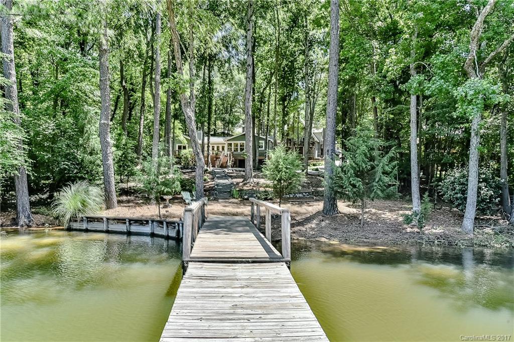 Hidden Treasure!Ranch on Level Waterfront site on wide deep water cove!Wrap around porch and decks to spend your time enjoying the sparkling views.Formal living, dining w/see through fireplace.Open kitchen/great room w/fireplace and travertine floors. Sunroom to enjoy the lake year round. 3 bedrooms plus an office.King size master with private deck and sumptuous bath with open tile shower,whirlpool bath,double vanities.Boat room underneath to store your water gear. Natural yard and awesome views