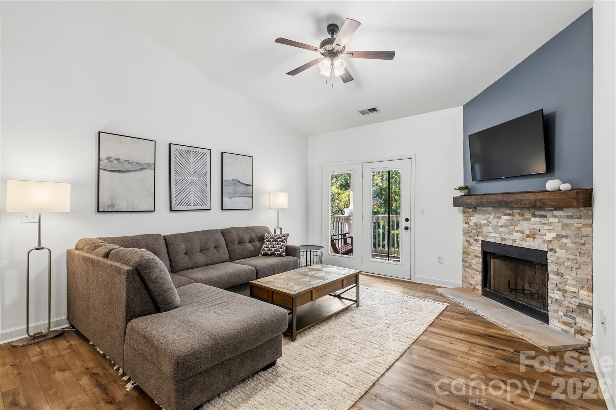 Welcome home to this bright and spacious 2-bedroom, 2-bath condo with a dedicated office, perfectly situated on the second floor in the rear of the community for added privacy and peaceful wooded views. This move-in-ready home features an open-concept floor plan with soaring vaulted ceilings, abundant natural light, and a cozy wood-burning fireplace that creates an inviting living space.

The beautifully updated interior includes wide-plank luxury vinyl plank flooring, neutral paint throughout, and a spacious dining area with updated lighting. The kitchen offers warm wood cabinetry, ample counter space, a pantry, and a functional layout that opens to the main living area, making it ideal for both everyday living and entertaining.

The oversized primary suite provides a relaxing retreat with a large walk-in closet and an ensuite bath featuring generous vanity storage. The split-bedroom floor plan offers excellent privacy, with a second bedroom and full bath located on the opposite side of the home. A separate office/flex space is perfect for working from home, a workout area, or additional guest space.

Additional highlights include a large laundry room with extra storage, a updated HVAC system, updated water heater, exterior storage closet, and a private covered balcony complete with a sliding screen door and privacy shades overlooking the trees.

The secure building offers controlled entry, convenient package delivery, and plenty of guest parking, including one assigned parking space. Residents enjoy fantastic community amenities including a swimming pool, clubhouse, tennis courts, and beautifully maintained grounds.

Located in the heart of the Ballantyne area, you'll be just minutes from shopping, dining, entertainment, parks, and major commuting routes. This is low-maintenance living in one of Charlotte's most desirable locations!