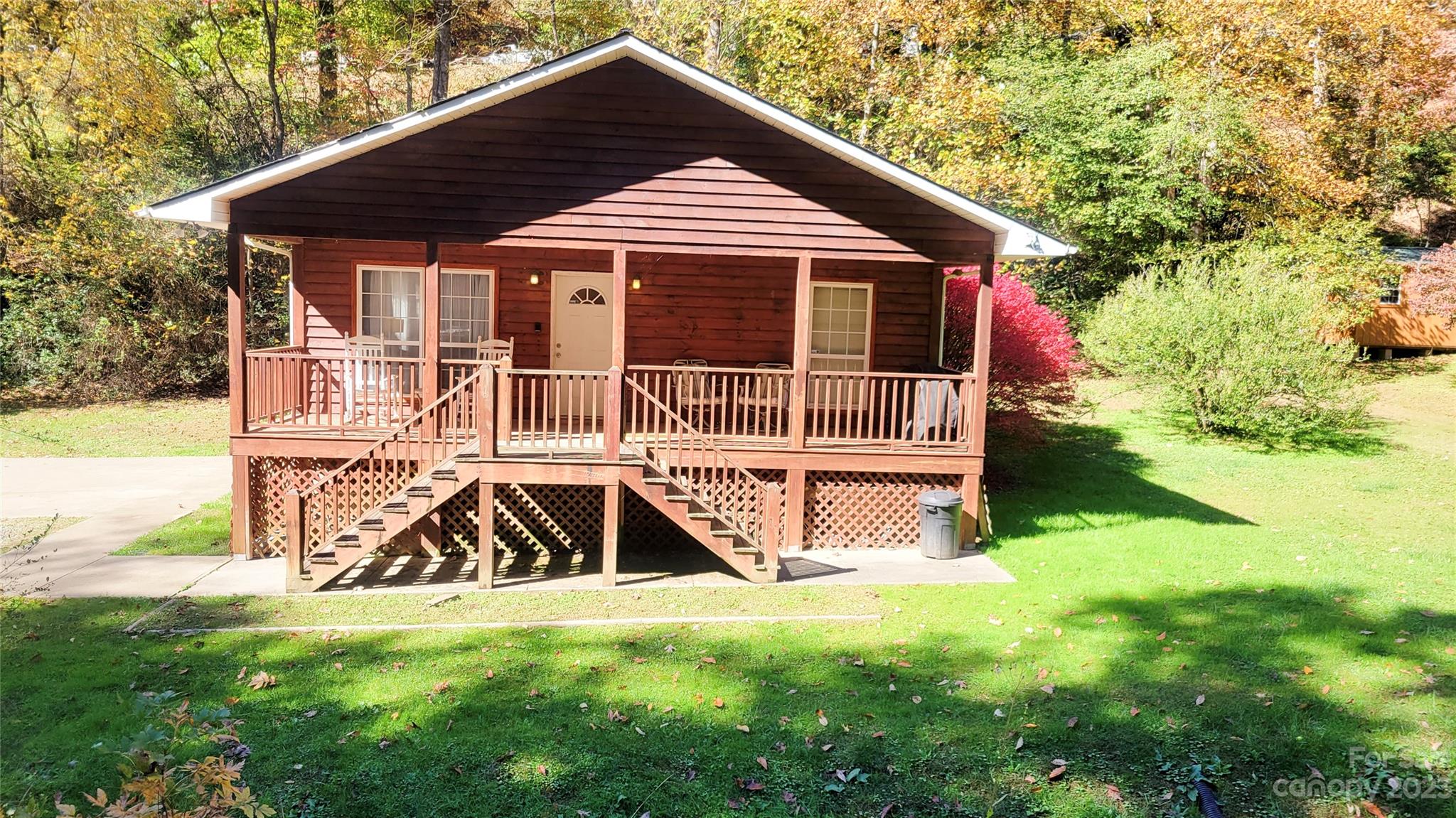 Nestled in the charming Deep Creek area, this vacation rental, just 2.1 miles from the Great Smokies National Park, seamlessly blends tranquility with nature's beauty. The flat yard, with a babbling brook, creates a serene backdrop. Enjoy the covered front porch or private rear deck for peaceful moments. The home features 2 bedrooms, 2 baths, vaulted tongue-n-groove ceilings, and walls for an inviting atmosphere. The large primary suite has a walk-in closet and ensuite bath. The updated kitchen, with stainless steel appliances and a breakfast bar, is a culinary haven. Fully furnished, this property embodies mountain living—comfort and natural beauty. Capture the essence of Deep Creek living!