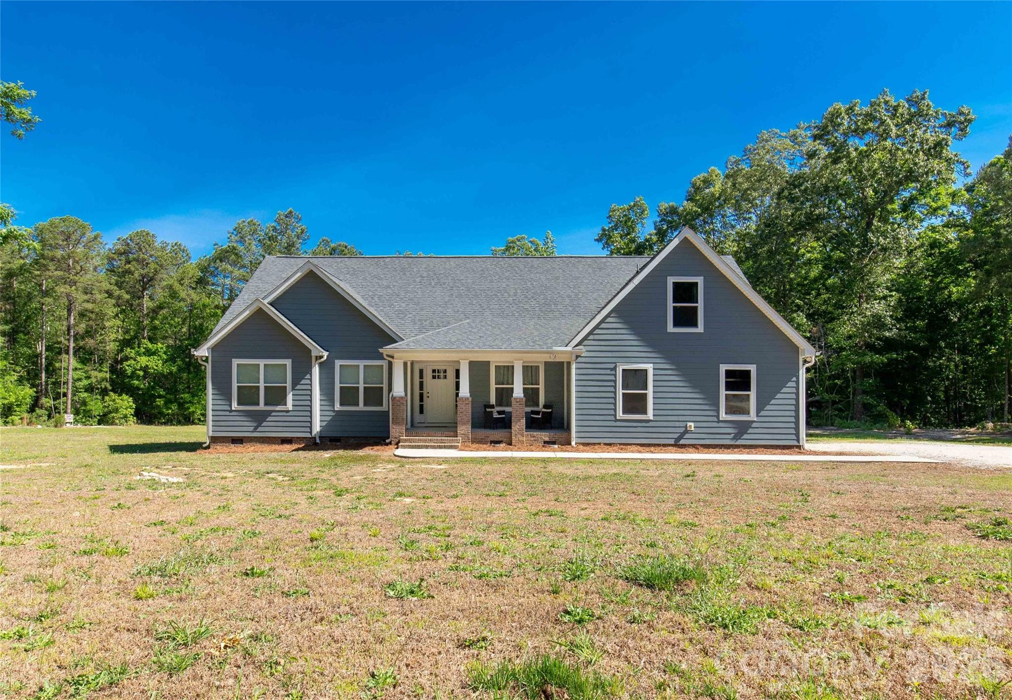 Tucked away on 14.289 acres of peaceful privacy, this home offers the kind of lifestyle buyers dream about but rarely find. Surrounded by room to roam, this property is perfect for those craving country living, outdoor adventure, or simply space away from neighbors. Whether you enjoy hunting, riding ATVs, keeping animals, gardening, or simply enjoying the quiet from your porch, this property delivers the freedom to live life your way.

Built with durable Hardie board siding and thoughtfully designed for both comfort and functionality, this spacious home features 4 bedrooms and 3 full baths on the main level, including TWO primary suites downstairs, making it an incredible setup for multi-generational living, guests, or added flexibility. Upstairs offers a large bonus room with an additional full bath that could easily serve as a media room, home office, guest retreat, or playroom.

Inside, the open-concept layout and split-bedroom floor plan create the perfect balance of togetherness and privacy. The main living areas flow effortlessly, making everyday living and entertaining feel easy and inviting. The windows bring in natural light and showcase the peaceful setting surrounding the home.

Outside is where this property truly shines. The 40x40 shop provides endless possibilities for equipment storage, hobbies, a workshop, recreational vehicles, or outdoor gear. A double garage, covered front porch, and back deck add even more space to enjoy the outdoors and take in the quiet surroundings. With over 14 acres, there is room for hunting, ATV trails, animals, homesteading, gardening, or simply enjoying the privacy that is becoming harder and harder to find.

Located in the highly desirable Buford School District and conveniently positioned near Monroe, Lancaster, Pageland, Waxhaw, and Charlotte, NC, this property offers the perfect blend of country living and accessibility.

If you've been searching for a private acreage home, home with land, newer construction (this home was built in 2021), multi-generational floor plan, property with a shop, hunting property, or mini farm potential in the Buford area, this one brings the whole country-living starter pack.