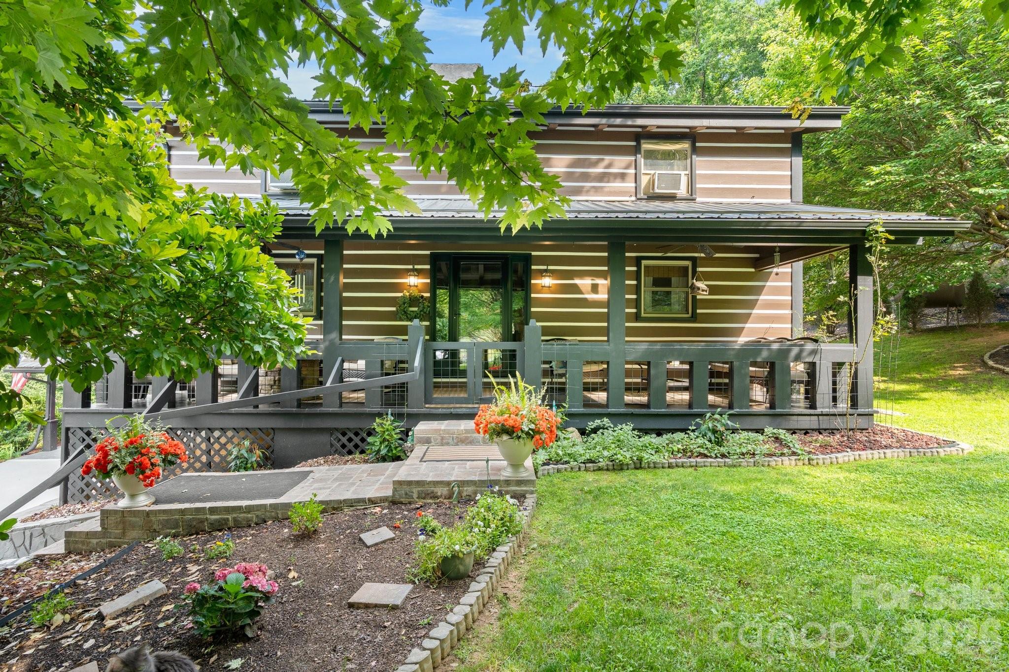 Beautiful 3BR/3BA rustic mountain cabin for sale near Lake James and downtown Marion! This well-kept home features a full front porch, exposed wood beams, hardwood floors, and a floor-to-ceiling stone fireplace. The open kitchen includes custom cabinets and stainless steel appliances. The main-level primary bedroom offers vaulted ceilings, a private deck, and a spa-like bathroom with a soaking tub, dual vanities, and a glass shower. Upstairs provides two additional bedrooms and a full bath—perfect for guests or Airbnb use. Outdoors, enjoy a fully fenced backyard and mature landscaping,. Short-term rental friendly, no HOA and move-in ready!