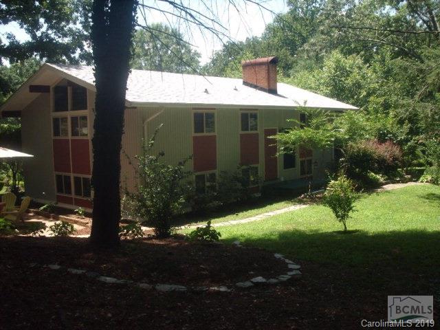 A 1954 Mid Century modern home designed by Carl Koch Architect - original hand drawn plans on file. Spacious home sitting on .64 acres in downtown Morganton with 2 Bedrooms 2 baths. Home has original doors, original bathroom fixtures and some original lighting. Kitchen has eating space and a bar. Great entertaining space with lots of room and 2 fireplaces. Walls of windows.  Home has a 2011 Solid state electric boiler as the primary heat source and 3 new (2015) portable A/C units which will stay with the home. New roof on house only installed in 2014. Carport (22.5 x 17.5) was enclosed to become a workshop (but the sliding doors could be removed and used as a carport again) with a wood burning unit and a window a/c unit ( which also stays).