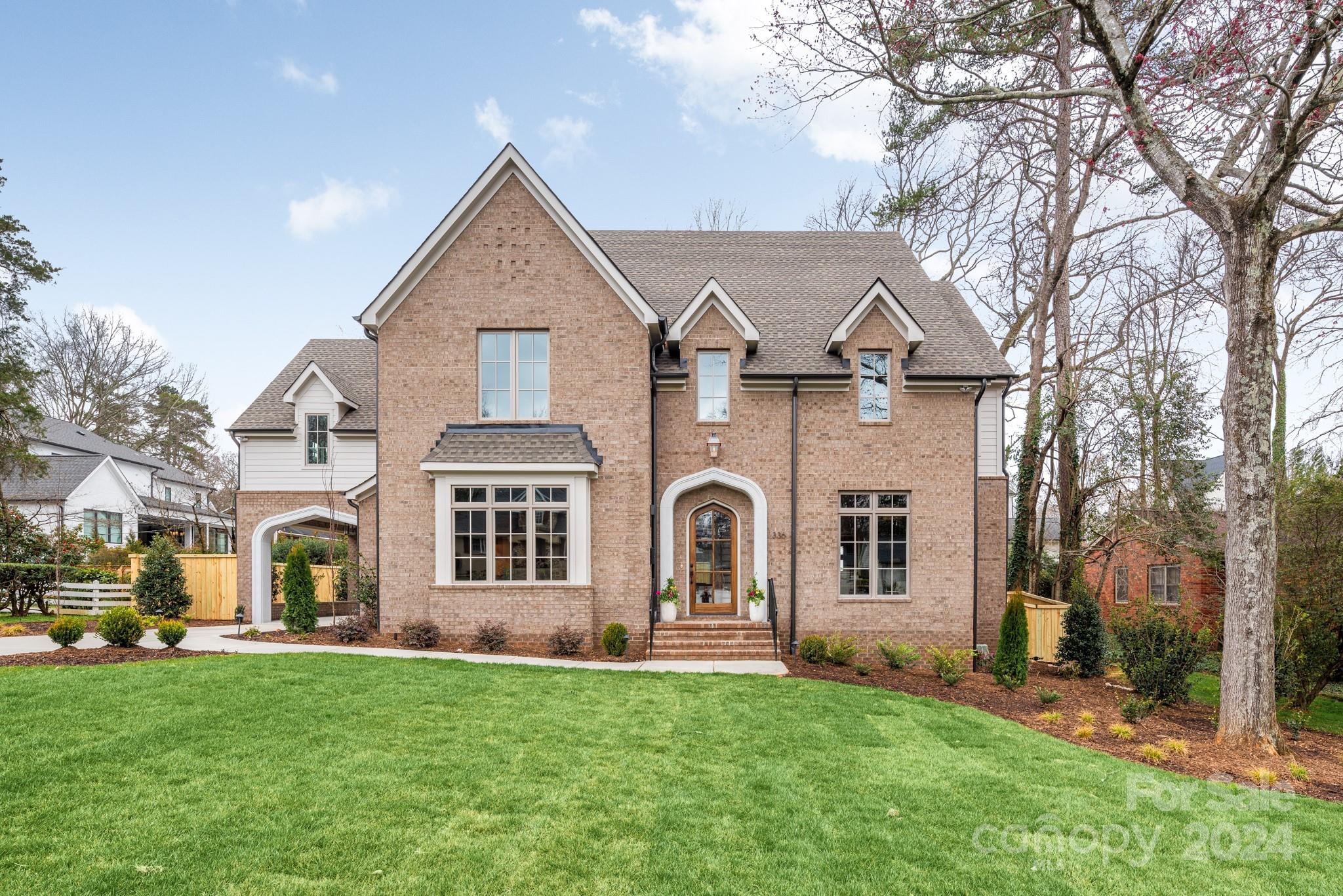 With a timeless, traditional facade, this new construction home in Charlotte's Cotswold neighborhood, sits on 1/3 of an acre, on a quiet residential street. Five bedrooms and 5.5 bathrooms, including a main floor primary suite, it  flows with sophisticated elegance. Entertain with ease in the open living spaces and chef's kitchen equipped with a Butler's Pantry and a working pantry for added convenience. Enjoy cool evenings by the fireplace on the screened porch or cookout in the outdoor kitchen. A porte cochere adds a touch of grandeur and the flat backyard with mature trees, provides ample space for outdoor enjoyment. Paneled study. The detached garage offers additional space upstairs, perfect for a guest suite or studio. With custom selections and exquisite lighting throughout, this home offers a truly tailored experience. Come see this stunning property today and experience luxury living at its finest in Cotswold.