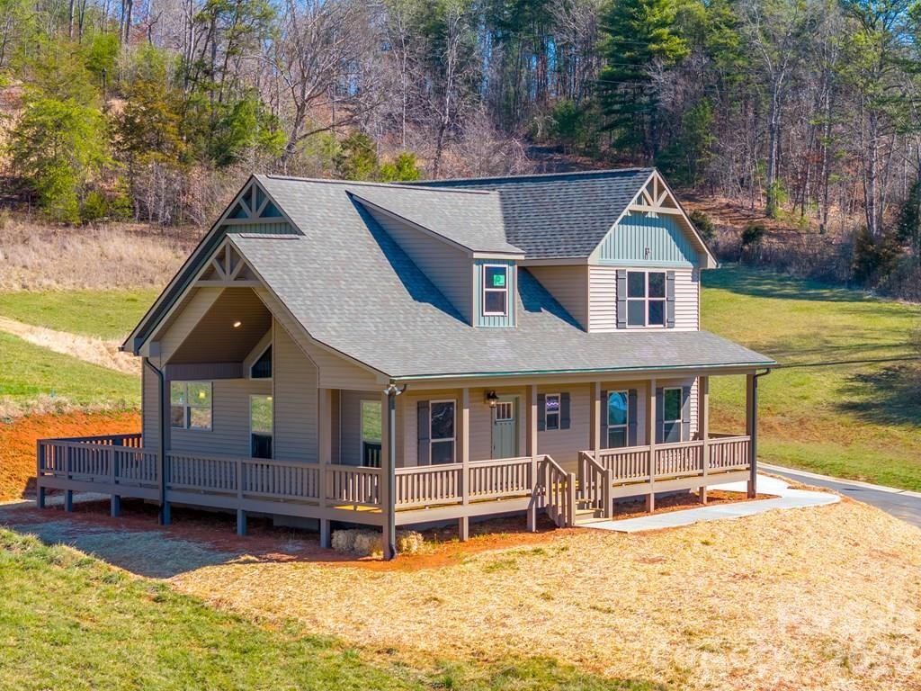Located within the city limits of Franklin, NC, this stunning new construction home blends modern comfort with mountain charm. Featuring 3 bedrooms and 2.5 baths, the thoughtfully designed layout offers soaring cathedral ceilings that create an open, airy feel throughout the living, dining, and kitchen areas.

The main level includes a spacious primary suite, convenient laundry room, and powder room for easy everyday living. Upstairs, you'll find two generously sized guest bedrooms and a shared full bath, providing plenty of space for family or visitors.

Step outside to the oversized covered porch, the perfect place to relax and take in the beautiful surrounding mountain views. This home offers the best of both convenience and scenic mountain living.