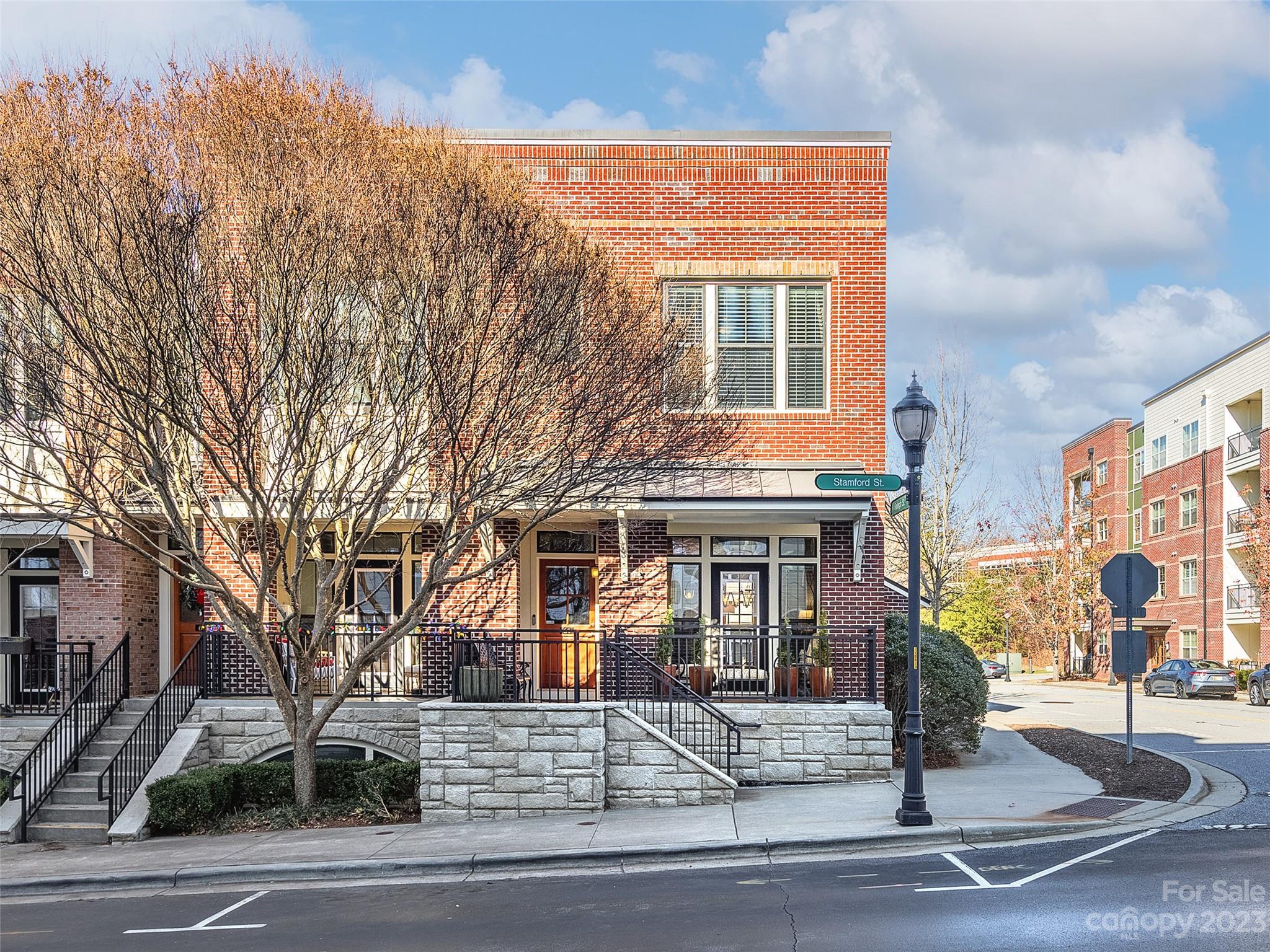 Exquisite brownstone condo in the heart of Biltmore Park. This rare end-unit features a multitude of windows that bring in lots of natural light. High ceilings, rich moldings, & wood floors lead to an attractive kitchen w/ granite & stainless. Trex deck affords mountain views. Cozy balcony at the front. Two spacious bedrooms upstairs feature walk-in closets & the primary has an inviting bath with granite vanity and tiled shower. Lower level houses the one car garage, storage, & a great bonus room with built-in storage closet. Forego the car! Boutique shopping, high-end dining, fitness venues & scenic trails are all at your fingertips!