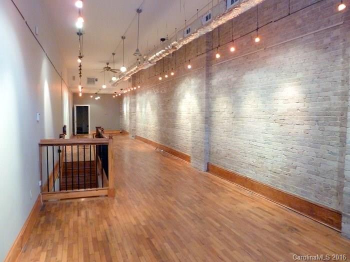 Rare opportunity to own a premier Downtown Asheville street-level commercial condo. This two-level retail space has approximately 1,260sf of finished space and 530sf of storage space. Entrance is directly off of College Street and only steps from Pritchard Park and Tupelo Honey Cafe. Private bath, high ceilings, beautiful exposed brick, perfect for boutique or art gallery. To be delivered vacant but recently leased with great cash flow on triple net lease.