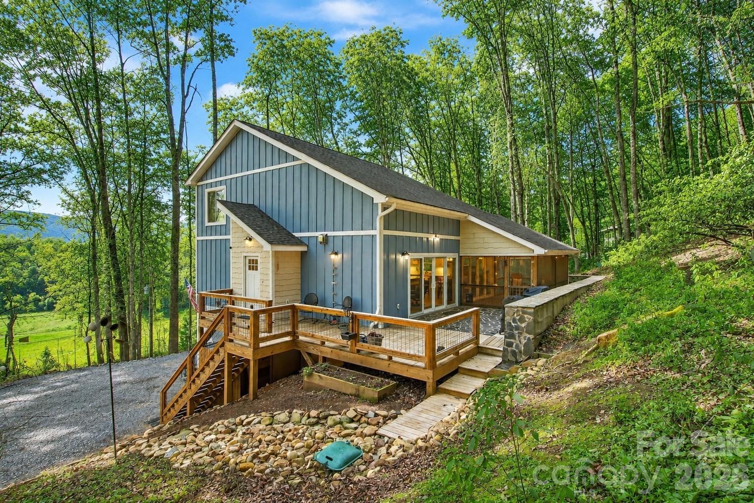 Custom-built in 2022 and truly move-in ready, with stunning mountain views and a base camp location for all the popular trails, fishing streams, and more. No HOA. Old Fort is just minutes away, with Black Mountain, Lake James, and Asheville all within easy reach. The natural landscaping is low-maintenance, giving you more time to enjoy family, friends, and the outdoors.

The main level features a spacious primary suite with its own private balcony—perfect for enjoying mountain views with your morning coffee. You’ll love the hand-crafted stone patio, open deck, and screened-in porch, ideal for relaxing or entertaining. Inside, the two-story great room showcases soaring ceilings and hardwood floors, creating a bright, open, and inviting space. The main level also includes a laundry room with ample storage and beautiful tile floors. With multiple decks and porches, you’ll enjoy outdoor living year-round.

Upstairs, you’ll find two bedrooms with large windows and mountain views, a full bath, and a cozy sitting area—perfect for reading, relaxing, or working from home.

The lower level offers extra storage, a 443 sq ft industrial-rustic style recreation room (kegerator negotiable, and owner will leave the wiring for easy reconnection), a utility room, garage, and an open workshop area—ideal for hobbies, projects, or creative space.

The exterior is low maintenance, and the thoughtfully designed landscaping blends perfeclt with the natural mountain setting. Follow the short trail to your own private fire pit and soak in the peaceful mountain atmosphere.

This home offers the perfect balance of views and convenience—just 5 minutes to Old Fort, 15 minutes to Black Mountain, and 30 minutes to Asheville. From 1413 Golf Course Road, you truly get the best of both city and country living—without sacrificing either. Short term rentals are allowed in this community.