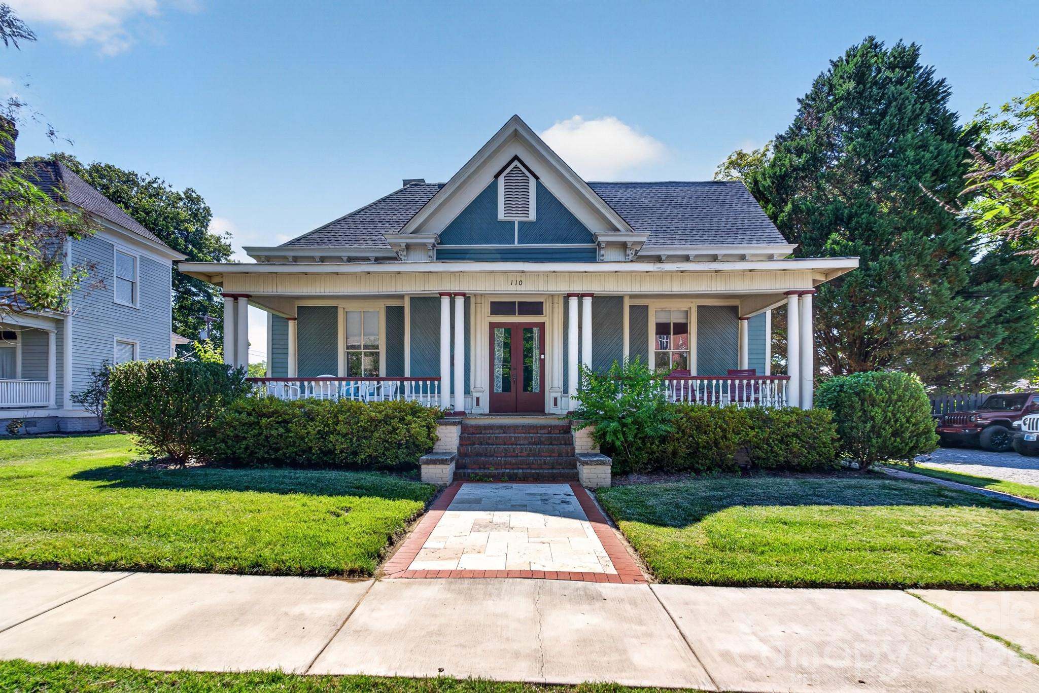 Located in the heart of downtown Rock Hill, this beautifully restored historic home blends timeless 1935 character with thoughtfully updated modern finishes. Featuring 3 bedrooms and 2.5 baths, the home offers an easy flowing open-concept layout designed for both everyday living and entertaining.

Walking up they kept the character on the extiero with woodslanted siding and all the craftmanship features including the front door. Large front porch for enjoying the weather and quiet. From the inviting living room at the front of the home to the charming arches throughout the foyer, every detail reflects the craftsmanship and charm of its era. Hardwood floors run throughout to provide seamless transitions, while the decorative original fireplace adds warmth and character to the main living space.

The updated kitchen is both functional and stylish, complete with a large island, pantry, and convenient drop zone area. Spacious bedrooms with personal fire places provide comfort and flexibility, while the private primary suite features beautiful windows, a walk-in closet, and a stunning walk-in shower.

Step outside to enjoy the back patio tucked behind the home, perfect for relaxing or entertaining. Just a few blocks from downtown, you can even catch views of Fountain Park while being minutes from shopping, dining, entertainment, and quick access to I-77.