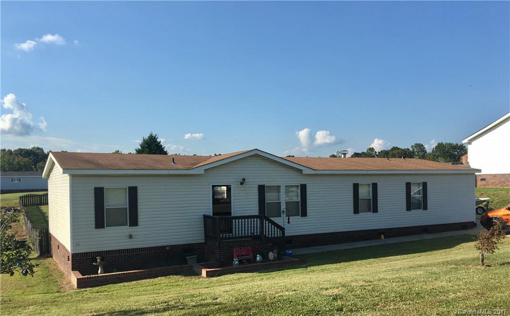 Amazing home on .68 acre lot, w/privacy fence. Stunning 27-foot round chemical-free pool w/lots of decking. Huge yard. Beautiful view of rolling hills from the newly built back deck. The home is manufactured double-wide (2008) w/3 bedrooms, 2 full baths. Open floor plan boasts both a living room & den. The den has a fireplace & exits out to this gorgeous backyard. Master bedroom suite with garden tub. Walk-in closets in all bedrooms. Kitchen is open, spacious with an island. Very well cared for.