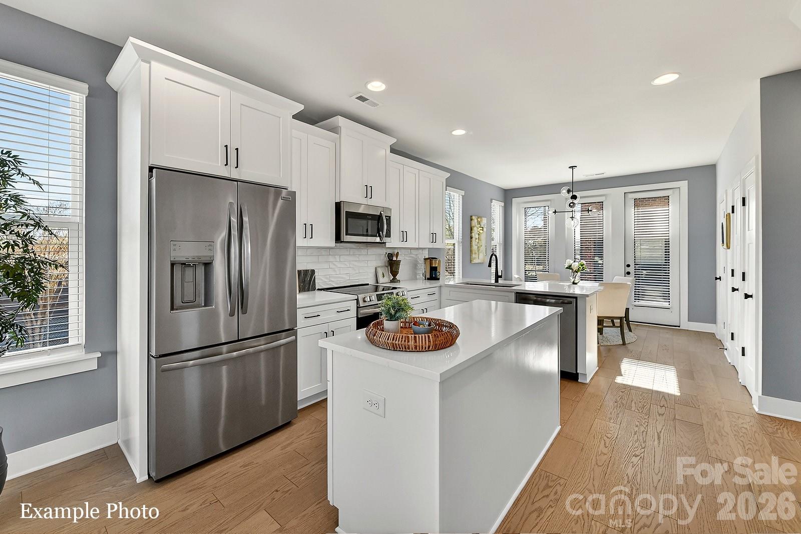 END TOWNHOME UNDER $500,000 JUST OUTSIDE UPTOWN, 3 BLOCKS FROM CAMP NORTH END. SELLER INCENTIVE: Receive up to $20,000 in Flex Dollars! PREMIUM LOCATION, LIVE IN A NEW, BEAUTIFULLY APPOINTED TOWNHOME WITH ROOFTOP TERRACE! Discover Modern Industrial Living at "North End Terraces". A Unique Townhome Community of 69 Homes w/ Modern Design, Artful Architecture & FENCED IN DOG PARK. Nestled between Charlotte's thriving Arts District, NODA, and the bustling Central Business District of Uptown. This home has 3 bedrooms, 2 full and 2 half baths, 2-car attached garage with EV charger and garage door opener. Upscale finishes including LVP floors throughout, plus oak tread staircases. Designer kitchen with white cabinets, quartz countertops, dark gray subway tile backsplash, stainless steel appliances including range, dishwasher & microwave. Primary bath features a large, tiled walk-in-shower with tile wet-bed, modern black fixtures, tiled floors in all full baths and more! This home is not to be missed! INVESTORS:NO RENTAL RESTRICTIONS.