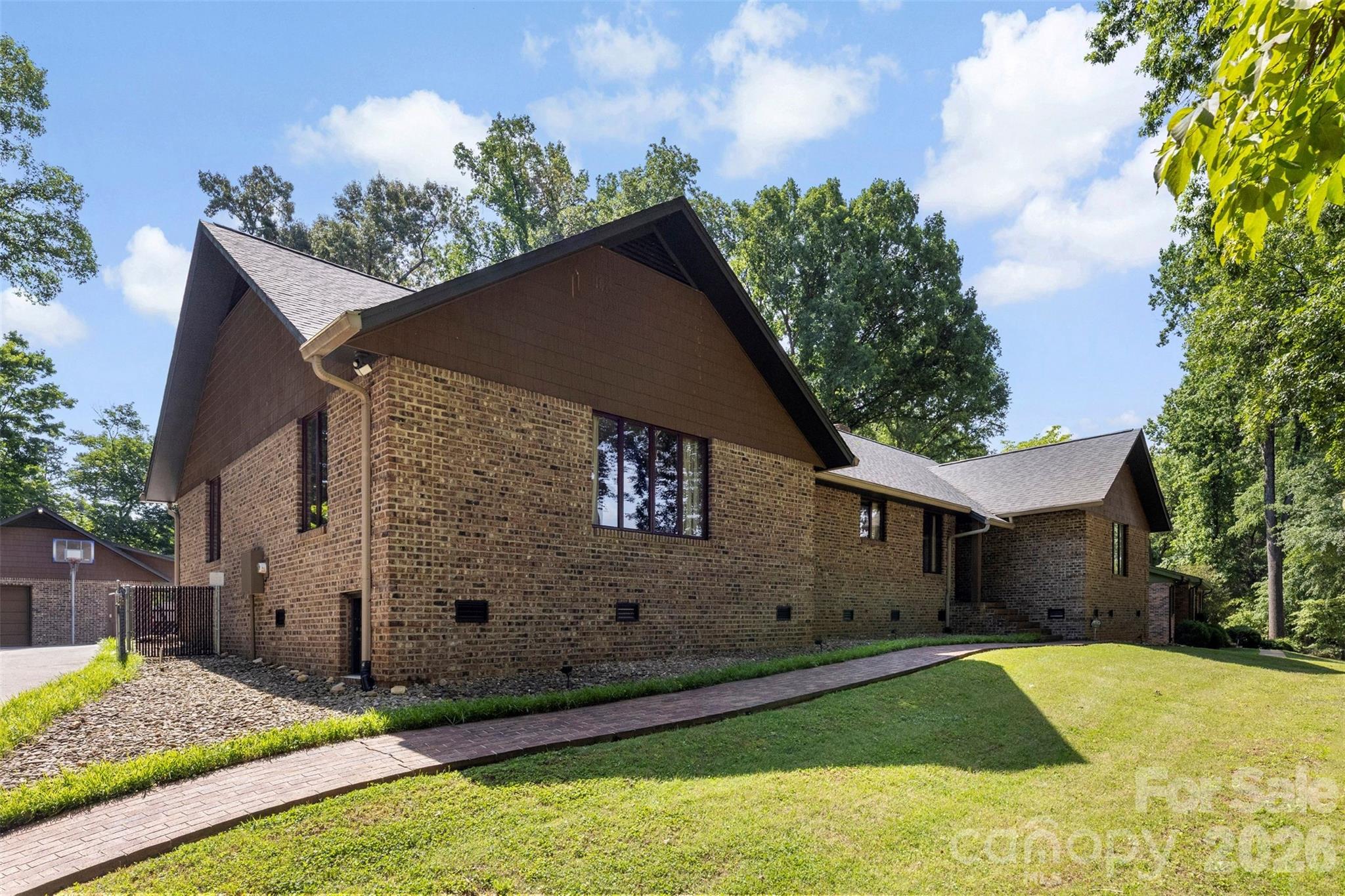 This beautifully maintained 4-bedroom, 2.5-bath single-family home in Mt. Holly offers 2,862 sq ft of thoughtfully designed living space on a generous 1.13-acre lot, making it an ideal choice for relocating buyers seeking room to grow and unwind. With its classic brick exterior, this home combines timeless curb appeal with modern functionality, providing the perfect backdrop for your next chapter in North Carolina.
Inside, you'll find a layout that balances openness with privacy, giving you plenty of room for home offices, guest suites, or hobby spaces.  Pull-down attic stairs provide easy access to generous attic storage, a valuable feature for organizing seasonal items, keepsakes, or overflow from a recent move. Every detail has been considered to make daily living more convenient and comfortable, whether you're hosting friends or simply enjoying a quiet evening at home.
The expansive 1.13-acre lot offers rare breathing room and flexibility, giving you space for outdoor entertaining, gardening, play areas, or future projects. Adding to the property’s unique character, there is a closed 1800's gold mine located on the property, a fascinating piece of local history that makes this homesite truly one of a kind.  The brick exterior not only adds enduring style but also provides durability, so you can spend more time enjoying your new home and less time on upkeep.
Location is a major advantage here. You'll be just 5 miles from Belmont and the U.S. National Whitewater Center, a world-class destination for outdoor adventure and recreation. Charlotte Douglas Airport is only 9 miles away, making travel seamless for work or leisure. Downtown Charlotte, with its dining, arts, and business hubs, is a quick 10 miles, while Gastonia offers additional shopping and services at the same distance. The home is also conveniently located near Lake Norman, Lake Wylie, and Mountain Island Lake, giving you easy access to boating, fishing, and waterfront relaxation. Whether you're exploring local trails, enjoying lake life, or commuting to the city, everything you need is within reach.
This is a rare opportunity to settle into a spacious, well-built home in a location that truly delivers on convenience and lifestyle.