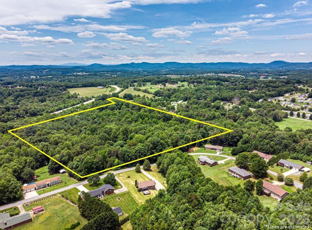 These 12+ acres are ready for new owners!  Located within a half mile of Alexander Central High School, this acreage is zoned R-1 which means you can have 4 single family residential properties per acre.  Close to the Alexander County Senior Center, shopping and all that downtown Taylorsville has to offer, this is a great central location to develop a small neighborhood!  Or have 12+ acres all to yourself and build your dream home!  There is a creek that runs the entire north end of the property.  City water available at the street!  This land is in an ETJ.  No City taxes.  There is a power line easement as well but still plenty of room for building!  Along the creek area is a flood plain.  Taylorsville is an All-American city that sits at the gateway to the Brushy Mountains, offering rolling hills, apple orchards, and hiking trails like Rocky Face Mountain.  Come take a look!  When using GPS, use address 243 Alexander Acres Drive to find this land!