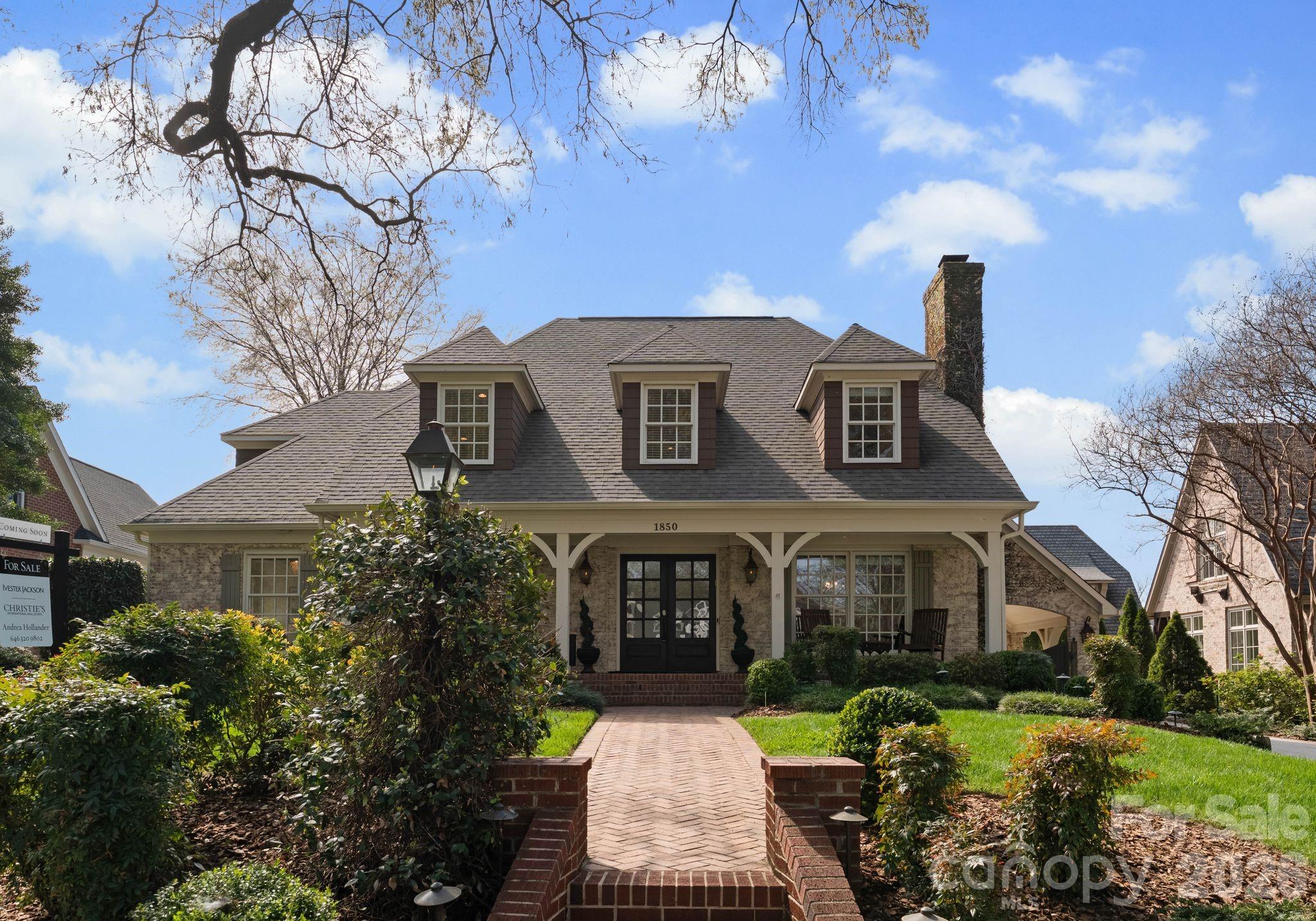 Elegant home with lovely curb appeal situated on one of Charlotte’s most desired streets, in the heart of Myers Park! This home showcases exceptional craftsmanship and timeless style throughout. This beautiful and welcoming home features newly refinished hardwood floors across the main level and an open, light-filled floor plan designed for both everyday living and entertaining. The chef’s kitchen is beautifully appointed with Thermador appliances, including a gas range, newly refinished and painted cabinetry, updated hardware, granite countertops, and a large island with a butcher block top. The kitchen flows seamlessly into the spacious great room, highlighted by a stunning stone fireplace, custom built-ins, and French doors that open to an expansive covered porch spanning the width of the home. The porch, complete with Trex decking, overlooks an entertainer’s dream backyard featuring an outdoor kitchen, pizza oven, fireplace, and firepit—perfect for relaxing with a morning coffee or hosting evening gatherings. The primary suite is conveniently located on the main level and features French doors opening to the covered porch. The spa-like primary bath with steam shower includes newly refinished vanities and elegant quartz countertops. Upstairs, a spacious bonus room with built-ins serves as the central focal point, and is ideal as a media room or playroom. The second level also includes two bedrooms connected by a Jack-and-Jill bathroom with double sinks, an additional bedroom with bonus space, a fourth spacious bedroom, and a second full bathroom.
A detached garage with second living quarters above features a private bedroom/bonus suite and full bath with a steam shower, offering the perfect space for guests, a home office, or studio, or an au pair.