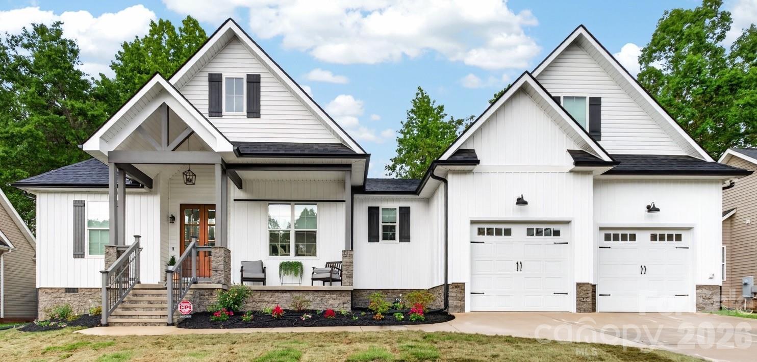 This like new construction that was built in 2025 is a beautiful home with the majority of living space on the main level.  The wooden double front door entrance way on the rocking chair front porch provides such a wonderful welcoming.   Step inside to the open floor plan featuring luxury vinyl plank waterproof flooring throughout.   The bright kitchen with quartz countertops, white cabinets, subway tile backsplash, island with farm sink, induction cooktop, stainless appliances, and butler's pantry is the perfect place to prepare meals, while overlooking the spacious family room.  Entertainment space is perfect with a separate dining room and breakfast area.  The primary bedroom suite features a spa-like bath with custom tile shower, freestanding tub, and separate vanities.   The spacious primary closet has the convenience of direct access to the laundry room.  Two additional bedrooms and a second full bath complete the main level.  Upstairs provides so many options for new buyers as it is home to a fourth bedroom (or bonus room) as well as a third full bath.  Looking for a private guest area?  This is it!  An oversized two-car garage provides room for your vehicles as well as great storage space.   With new sod in the front and new landscaping, this one is ready to impress.  As the newest home in Stafford Park, this home was built by the current owners as their “forever  home,” but they are being relocated to another state, opening the door for you to make 2358 Keswick Lane your next address.