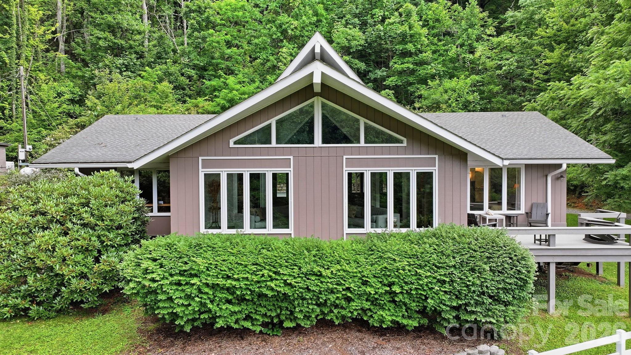 This listing is for the sale of 2 adjoining properties, 560 Winchester Creek Rd (1.48 acres) and 484 Winchester Creek Rd (2.02 acres). These 2 separate parcels can be sold individually at a later date if desired. 

Originally envisioned as a single-family homesite, this exceptional 3.5-acre Winchester Creek retreat has been thoughtfully renewed and expanded into a special mountain sanctuary. Two separate structures offer a combined total of 4 bedrooms, 4.5 bathrooms and 3,217 square feet of living area.

The oversized climate controlled RV garage below the main house adds another 1,350 square feet with dedicated electrical and plumbing connections along with a half bath. The upstairs 675 square foot loft features a bright modern living space with sleeping area, kitchenette and full bathroom.

Perched above the surrounding landscape and tucked away on a private road, the property offers a rare combination of privacy, serenity, and long-range mountain and pastoral views. The main residence and the newly completed (2024) multi-use guest quarters provide remarkable flexibility for a variety of lifestyles. Multi-generational living, extended-stay guests, or short-term rental opportunities are all viable options.
The 2,542 square foot residence is warm and inviting, designed for comfort and year-round enjoyment. Large windows frame the surrounding natural beauty, while the outdoor deck becomes a true extension of the living space.  All three bedrooms in the residence have en suite baths. Whether you’re sipping morning coffee as the sun rises over the mountains or unwinding in the evening beside the huge stone fireplace, the setting is peaceful, restorative, and unmistakably Western North Carolina.

Designed with reliability and peace of mind, the property includes two whole-house standby generators, ensuring uninterrupted comfort in every season. The land itself is a highlight—gently rolling, beautifully maintained, and bordered by the natural beauty that defines the Winchester Creek area. Step outside your door and explore the neighborhood’s scenic trails, streams, and waterfalls, or take on the adventure of hiking to the iconic Lyn Lowry Cross. Wildlife sightings, star-filled night skies, and the soothing quiet of nature create an atmosphere that feels worlds away, yet the conveniences of town are remarkably close.

Despite its private setting, the location is exceptionally convenient. You’re just 10 minutes from downtown Waynesville, with its vibrant arts scene, local restaurants, and year-round events. Asheville, the Biltmore Estate, and the Asheville Regional Airport are all within a 30-minute drive, making travel and day trips effortless. Outdoor enthusiasts will appreciate being only one mile from the Blue Ridge Parkway, one of America’s most treasured scenic byways and 45 minutes from the Nantahala Outdoor Center, full of water sports, ziplining, mountain biking, hiking and more. Charming mountain towns including Sylva, Highlands, Franklin, Bryson City, and Cherokee are all within easy reach, offering endless opportunities for exploration, dining, shopping, and recreation.

With an extensive list of recent improvements and upgrades (see attached documents) this remarkable property offers a rare blend of comfort, versatility, and natural beauty. Whether you’re seeking a private mountain retreat, a multi-generational compound, an income-producing property, or a home base for adventure, this Winchester Creek sanctuary delivers an unparalleled opportunity to experience the very best of mountain living in Western North Carolina.

Many of the furnishings pictured including a 2024 Kawasaki Mule Pro-MX EPS are negotiable.