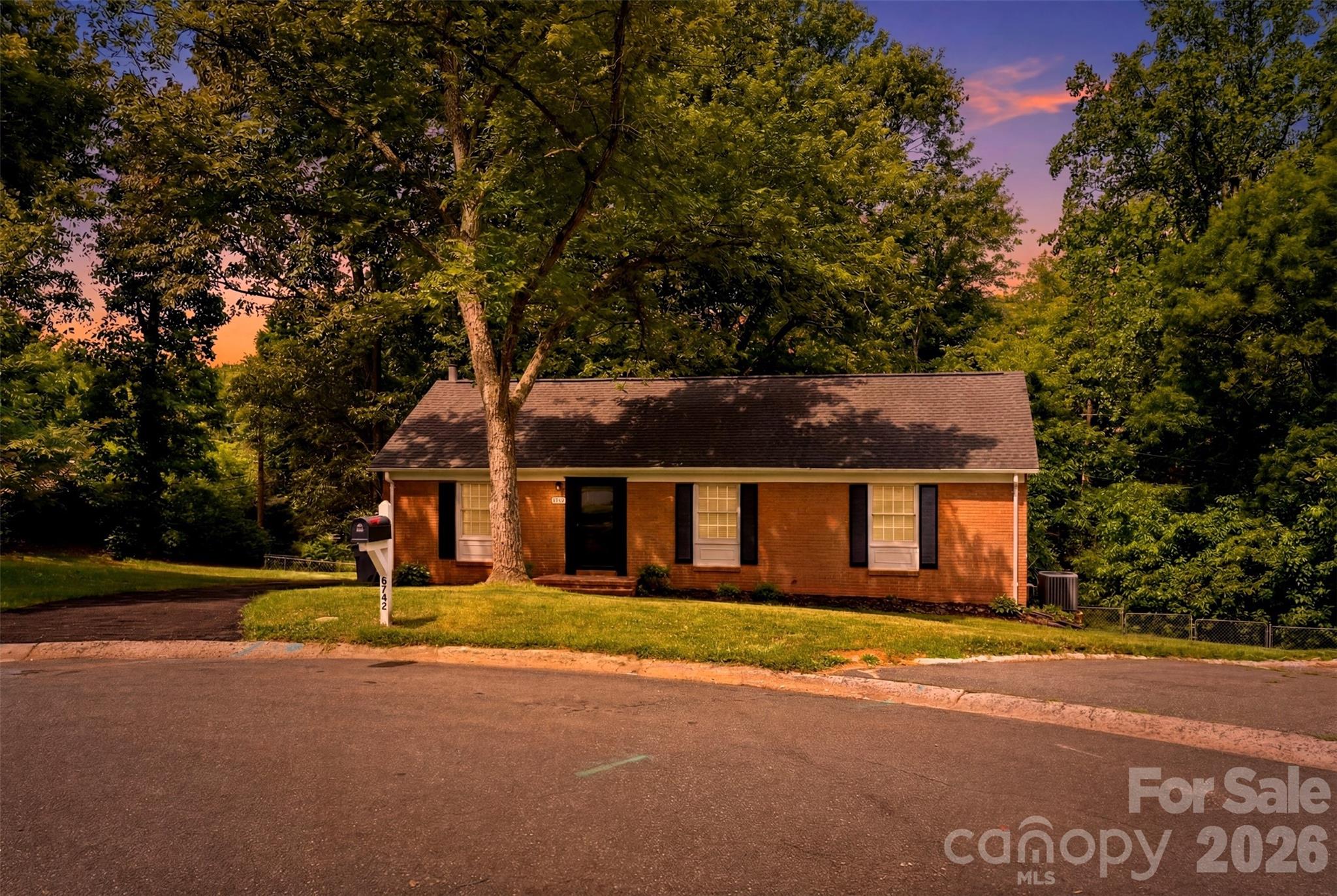 Welcome to 6742 Wild Turkey Ln — an all-brick ranch tucked at the end of a quiet, low-traffic cul-de-sac in the established Pawtuckett neighborhood of Charlotte, NC. Sitting on .619 acres with a creek running along the back property line, this home offers something hard to find this close to the city of Charlotte: room to breathe, mature hardwood trees, and a fully fenced backyard with space to spare.
Step inside to refinished oak hardwood floors that run throughout the main level, paired with fresh neutral paint, abundant natural light, and ceiling fans in the main living spaces. The open-concept living and dining area is anchored by a custom archway that adds warmth and character, and it flows seamlessly into the kitchen. There you'll find ample custom cabinetry, stainless steel appliances, granite countertops, a slate stone-tile floor, and a stacked-stone backsplash that gives the space a standout, finished look.
The main level offers three bedrooms and two full baths, including a primary bedroom with its own private en-suite bath. Two additional linen/storage closets in the hallway add everyday convenience and keep the home clutter-free.
Downstairs, the full basement dramatically expands how you can use this home. A large heated-and-cooled bonus room — anchored by a stone-surround wood stove — makes a flexible rec room, media room, home office, or hobby space. Beyond that, generous unfinished areas provide excellent storage, workshop potential, and the opportunity to finish out even more living space down the road, with laundry hookups already in place.
Outside, the possibilities continue. A 12' x 16' powered storage building/workshop is ideal for tools, projects, or extra storage, and a gas hookup makes grilling easy. The expansive fenced yard leaves plenty of room for a garden, recreation, and enjoying the peaceful, tucked-away setting.
Location keeps you connected while still feeling like a retreat: just minutes to the U.S. National Whitewater Center, Charlotte Douglas International Airport, uptown Charlotte, and quick access to I-485 and I-85 for commutes in nearly any direction.
With solid all-brick construction, refinished hardwoods, a versatile finished basement, real outdoor space, and a creekside lot at the end of a cul-de-sac, 6742 Wild Turkey Ln is a rare blend of comfort, character, and opportunity in one of Charlotte's convenient established neighborhoods.
Approximately 1,550 heated square feet plus roughly 800 square feet of unfinished basement space, in addition to the 12' x 16' workshop. Buyer to verify all square footage, lot size, and schools.

For all up to date information, please contact listing agent directly.