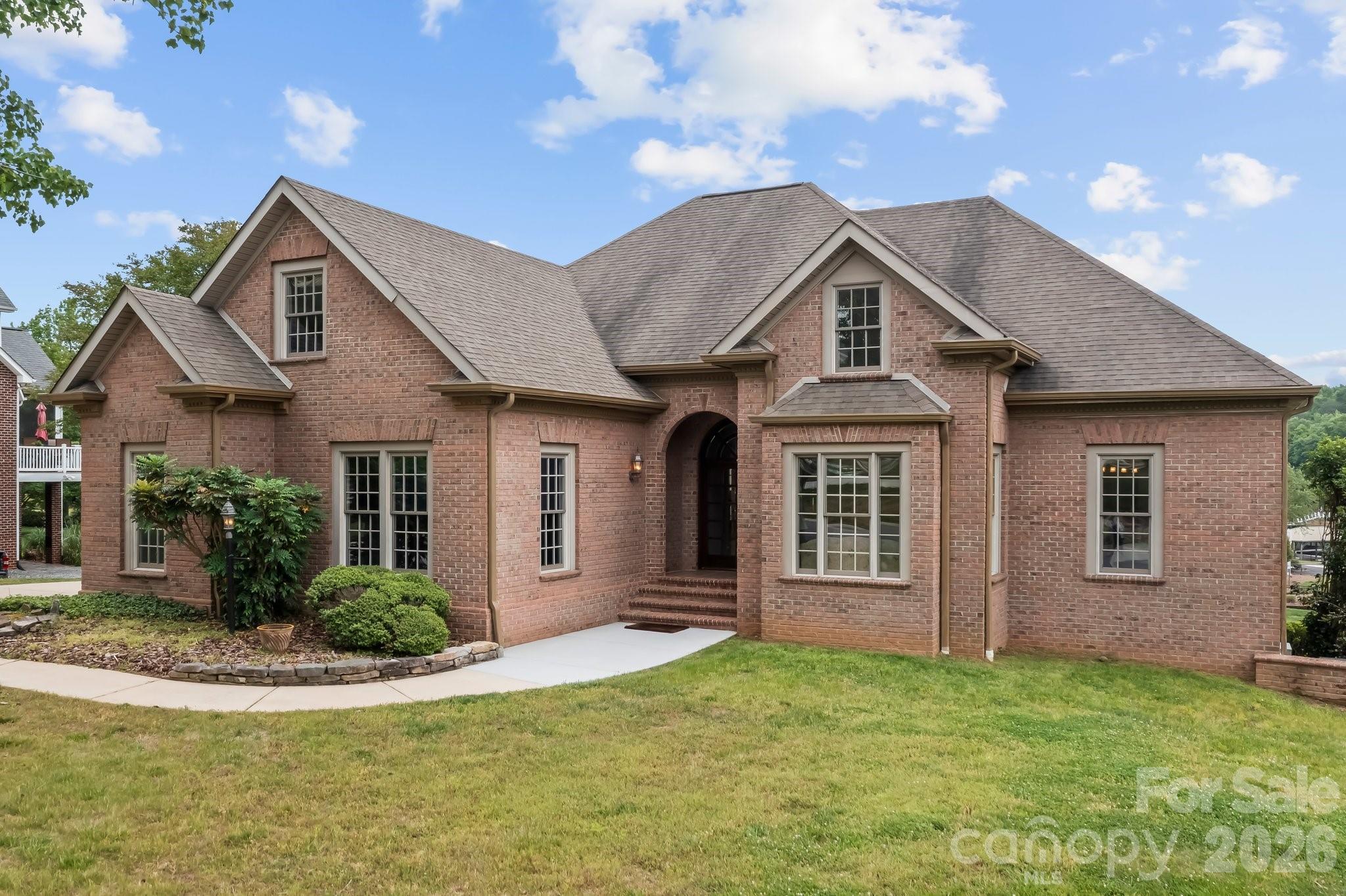 Experience exceptional lakeside living in this custom-built, one-owner home located on the coveted Lake Norman main channel (on the no-wake side of Windemere Island), offering stunning views of the island and lake. This rare waterfront property includes a community boat slip, with lake management indicating potential for a private dock, enhancing your access to the water. Nestled within the desirable Windemere community, residents enjoy exclusive amenities such as a boat and RV storage lot, a game court, a lakefront pool, community boat slips and dock, plus a welcoming clubhouse. Outdoor enthusiasts will appreciate the close proximity to Lake Norman State Park, perfect for hiking, fishing, and other adventures, while the nearby Town of Troutman provides convenient local amenities.

Boasting over 7,500 square feet under roof, this expansive residence features six spacious bedrooms—each equipped with walk-in closets—four full bathrooms, two half baths, and ample parking with a four-car garage setup, including a side-load two-car garage on the main level and a tandem two-car garage in the basement. The main-level primary suite is a true retreat, complete with an ensuite bath, tray ceiling, a generous walk-in closet, balcony access, and picturesque lake views. An additional main-level bedroom also offers an ensuite bath for guests or family.

The heart of the home showcases an open-concept floor plan where the kitchen, great room with a cozy gas log fireplace, and breakfast nook seamlessly flow together, all enjoying serene lake vistas and entry to a covered balcony. Functional design is emphasized with a main-level laundry room featuring pocket doors, alongside formal living and dining rooms ideal for entertaining.

Upstairs, a media room with a wet bar and beadboard ceiling invites relaxation and gatherings, complemented by a bonus room and two bedrooms—one with a convenient half bath. The walk-out basement expands the living space with two additional bedrooms, a full bathroom, a family room featuring built-ins, a wet bar, and a see-through gas log fireplace. Additional rooms include a versatile flex space, access to a screened-in porch and veranda, a vast unfinished storage area perfect for a workshop, a utility room, and the tandem garage.

The sellers are offering $25,000 in seller concessions to the buyer, providing added value and opportunity. This remarkable lakefront estate offers a harmonious blend of luxury, comfort, and recreational opportunity, making it an ideal sanctuary for those seeking an elevated lifestyle on Lake Norman. Don’t miss the chance to call this prestigious Windemere address your new home.