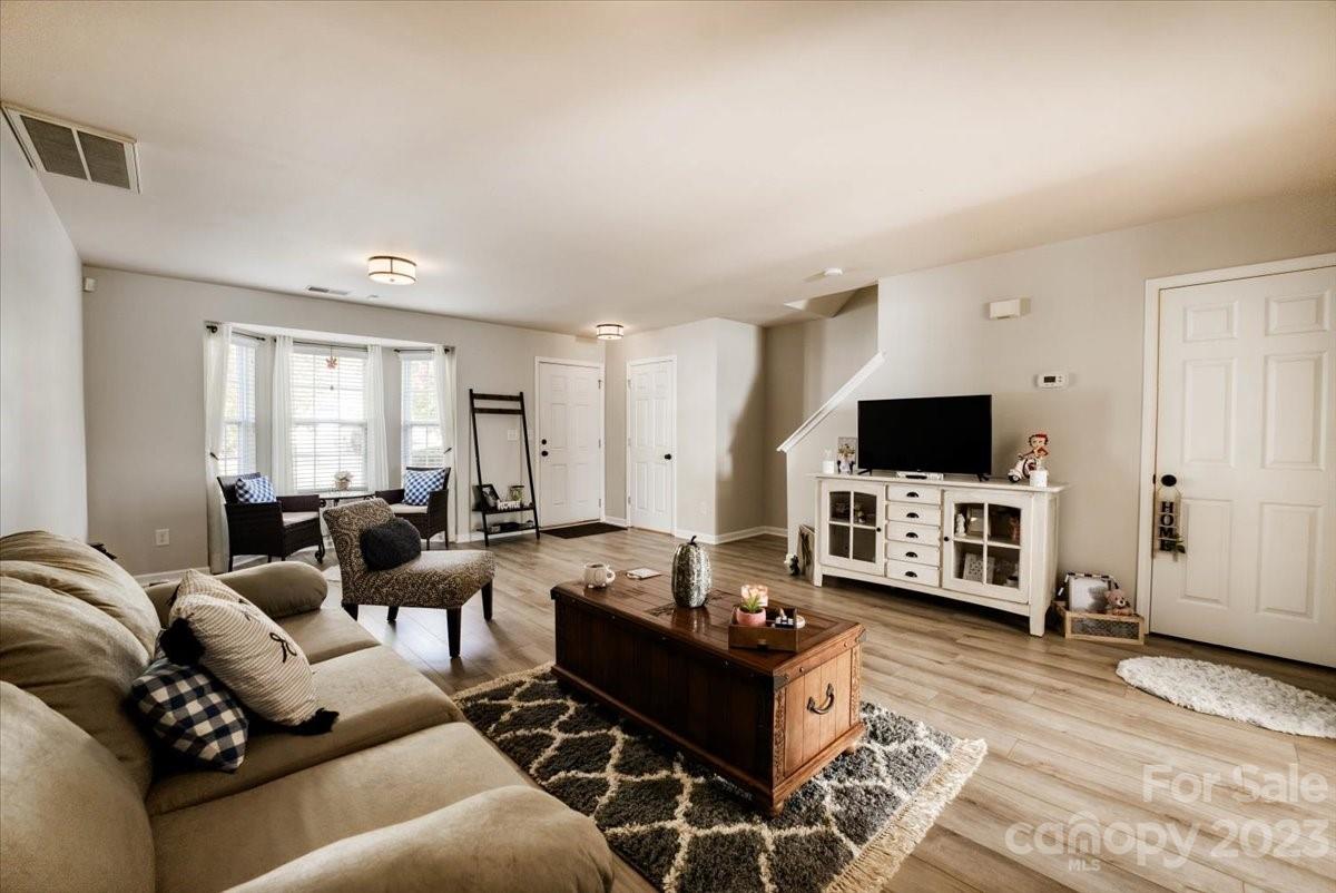 Take in the view as you are welcomed into a spacious living room area upgraded with fresh paint and absolutely breath taking luxury vinyl flooring that is continuous throughout the main level. Relax in the sitting area by the  bay window for views of the tree lined streets with sidewalks. This townhome boasts of a lovely kitchen with a large island laid with granite. Wainscot trim along the entrance to the kitchen and dining area bringing elegance to the space. Large walk in pantry. Take a peek through the French doors to notice possibly the largest backyard for a townhouse that you've ever seen - Fully fenced! Upstairs, the plush carpet springs comfortably under your feet with each step. The primary bedroom is warm and inviting with a walk in closet and on suite that features double sinks, a soaking tub and an oversized shower. Ample storage. All new toilets. 2022 Water Heater. Condensor with new parts. Also, the community pool is being renovated in preparation for summer!