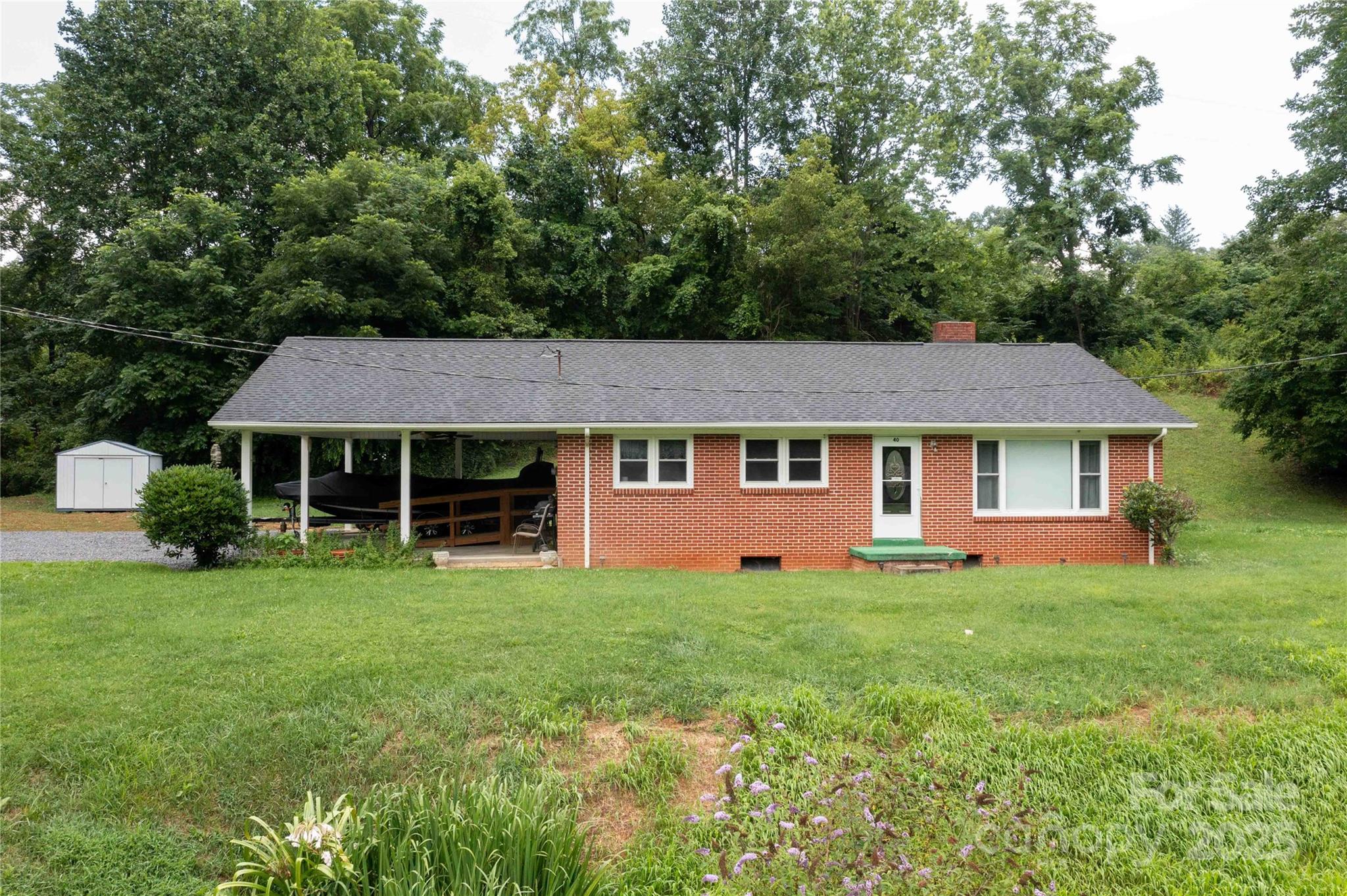 This charming 3-bed, 1-bath brick home is designed for both comfort and convenience, and comes with a burbling creek on one side of the property. Featuring a full basement and some brand-new appliances, it is ready for your personal touches! The cozy kitchen makes meal prep effortless and enjoyable, with dining area for family meals. A full basement provides endless potential—whether you envision a home gym, entertainment space, extra storage, or the opportunity to finish it into additional living space. Sit and listen to the burbling sound of the creek from your bedroom window while drifting off to sleep. With its classic brick exterior, this home offers both durability and curb appeal, requiring minimal upkeep. Perfectly located near national parks and the BRP, as well as easy shopping, this home is also within easy commuting distance of Asheville, giving you access to both peaceful living and vibrant urban amenities. Don't let it slip by, and book your private showing today!