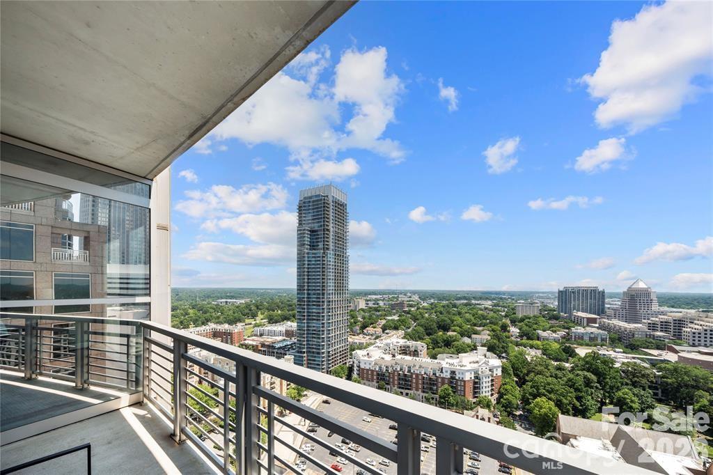 Million dollar views take center stage in this spectacular 22nd floor corner residence at Trademark.The most stunning long views can be found from the living room, primary bedroom, and private balcony, where sweeping sunrise views and an ever changing skyline create a truly unforgettable backdrop to everyday life.
The bright and airy open concept floor plan is surrounded by floor to ceiling windows, flooding the home with natural light while showcasing the incredible views from nearly every room. The balcony, located just off the living room, offers the perfect place to enjoy your morning coffee, unwind after work, or entertain guests high above the city. Both bedrooms feature blackout shades, providing perfect comfort and privacy. Brand new laminate wood flooring installed in 2025 adds a fresh, modern touch to the home's sophisticated design.
Meticulously maintained and move in ready, this residence has been thoughtfully updated with fresh interior paint, a new HVAC system and water heater in 2023, a dishwasher replaced in 2023, and a washer and dryer from 2021. Adding even more value are two deeded parking spaces located in separate gated parking areas, a rare and highly sought after convenience in Uptown living.
Ideally located in the heart of Uptown Charlotte, you're just steps from Bank of America Stadium, Spectrum Center, Truist Field, and some of the city's best dining, shopping, entertainment, and nightlife. Residents of Trademark enjoy premier amenities including a resort style pool, gym, outdoor grilling area, stylish resident lounge, and a dog friendly atmosphere.
With its prime Uptown location, thoughtful updates, and rare inclusion of two deeded parking spaces, this exceptional residence offers both luxury and convenience. Furniture is negotiable, creating a fantastic turnkey opportunity!