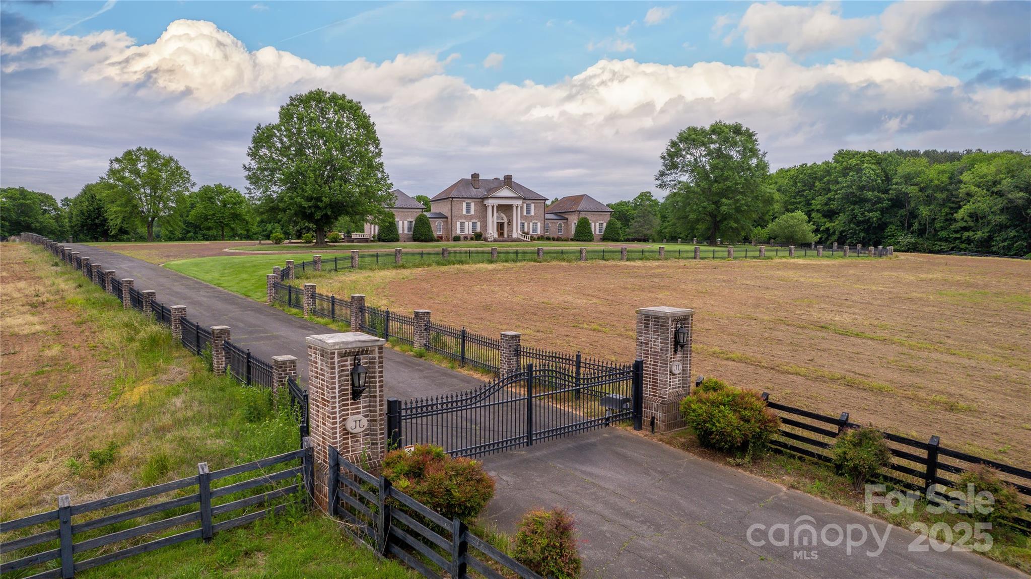 Step into a world of luxury at the former executive estate of a NASCAR legend, nestled in the picturesque town of Hamptonville. This stunning property encompasses everything you'd expect from a premier country retreat, offering both elegance and comfort. Beautifully designed pool house, perfect for leisurely afternoons spent lounging by the water. Guests will feel right at home in the charming guest house, which provides a cozy getaway for friends and family. The dedicated race shop is a dream come true for racing enthusiasts or hobbyists, equipped with everything needed to service cars and motorcycles. Additionally, the farm shop offers ample space for those who enjoy woodworking, crafting, or tending to the land. The property is dotted with numerous barns, each adding character and utility, along with vast pastures waiting to be explored. Embrace the tranquility of country living while enjoying the conveniences of modern luxury.