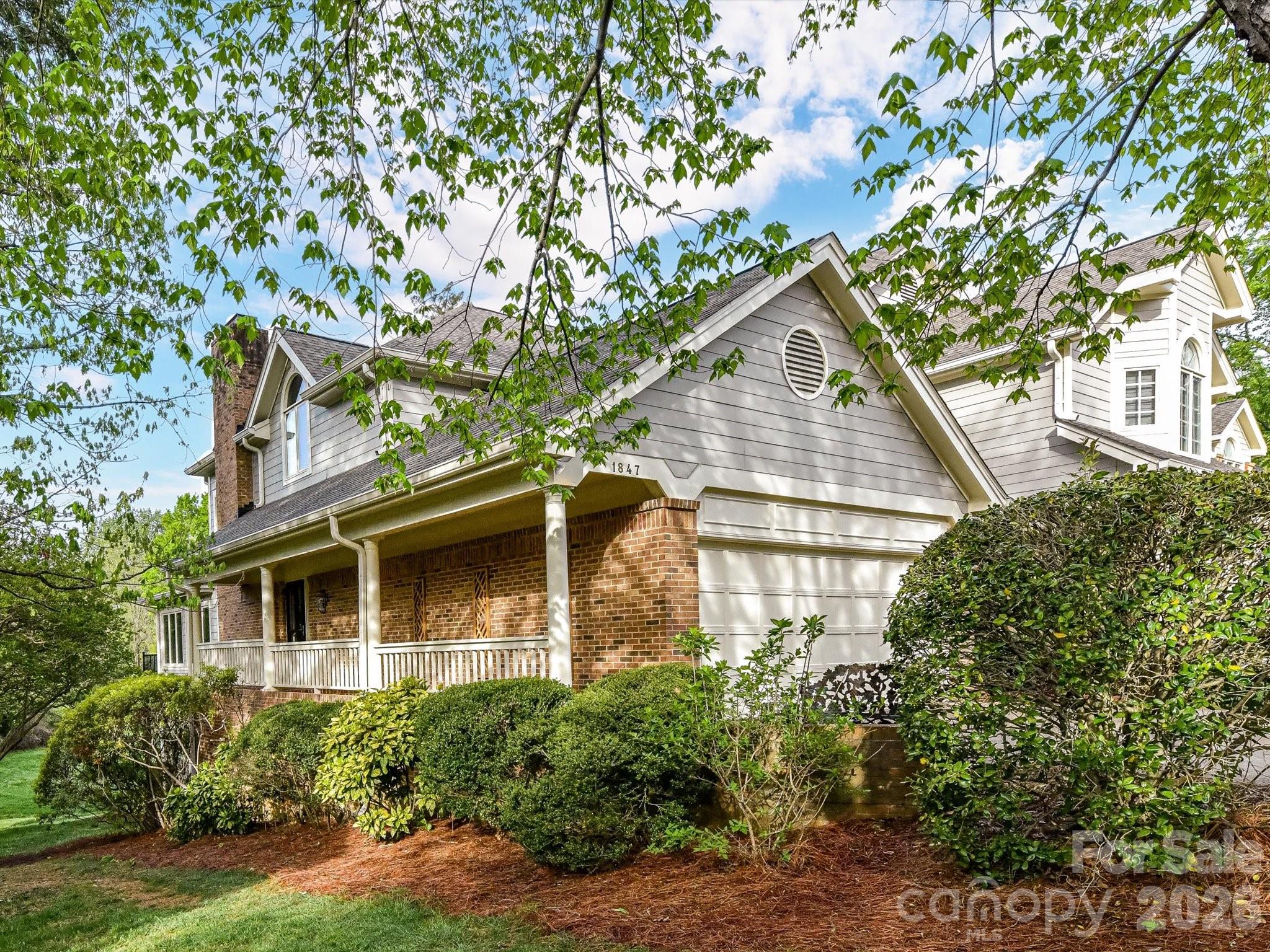 As you enter you're greeted by lofty two story ceilings, gracious moldings, plantation shutters, warm wood floors and amazing light. There are multiple living spaces but the floor plan feels open and airy; the enclosed sun room provides views across the expansive meadow, a sight rarely seen in this part of town. The kitchen features a top of the line induction cooktop, double ovens, and a great flow - additional cabinetry in the breakfast area is so practical.  Outdoors the screened porch and the deck span the entire back of the home and again highlight the gorgeous natural view. The primary suite is on the main level, with a custom walk-in closet and a laundry hookup behind the vanity in the bathroom for convenience.    

Upstairs the loft centers around a beautiful arched window with built ins underneath, and two bedrooms; all are newly carpeted and ready for the new owners. The basement area could be it's own apartment; there's a family room with fireplace open to the kitchen, a bonus room that would make an excellent movie or workout room, storage closets (one cedar), a bedroom and bath, and a utility room with full laundry.  

This is one of very few units in the community with a basement, 2 car garage and large driveway; there is great storage in the space above the garage as well. Premier location off Providence, steps away from Strawberry Hill with great shopping, dining and a Fresh Market grocery and minutes from Southpark Mall.