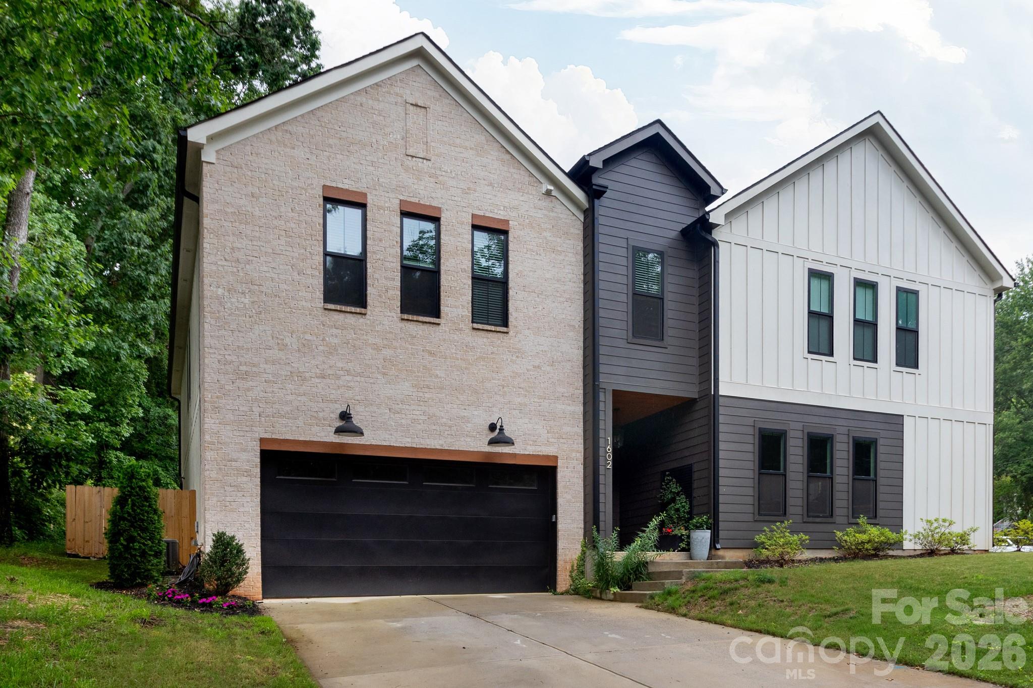 The opportunity to live in 28205 in a luxury style home for under a million is scarce! Welcome to 1602 Herrin Avenue,  where you don't have to choose between style and space in the Queen City's HOTTEST ZIP CODE. This stunning duet delivers on every front, offering 4 bedrooms, 3.5 baths, and a two-car garage in a layout where every single inch feels intentional. Forget the cookie-cutter finishes; we’re talking, designer tile 
+ lighting selections, and custom ceiling-high cabinetry that gives the home an effortlessly elevated vibe.

The kitchen is a showstopper, anchored by crisp quartz countertops and an expansive (no-joke) walk-in pantry. No need to put your deep freezer or back-up fridge in the garage.  Live edge shelving adds that perfect organic touch to the space, making it feel warm and lived-in from day one. Love hosting, the living area flows right onto a covered patio, creating a seamless indoor outdoor setup for weekend BBQs, evenings by the fire pit, and morning coffee.

Retreat to a primary suite that feels like a true sanctuary, complete with a WET ROOM (soaking tub and walk-in shower) with dual heads, and a closet that actually fits your entire wardrobe. Upstairs, life stays organized with a dedicated laundry room and three additional bedrooms, giving everyone plenty of space to breathe.

Located just moments from the energy of NoDa and Plaza Midwood, and a quick 15-minute hop into Uptown. Best of all, NO HOA fees eating away at your budget!