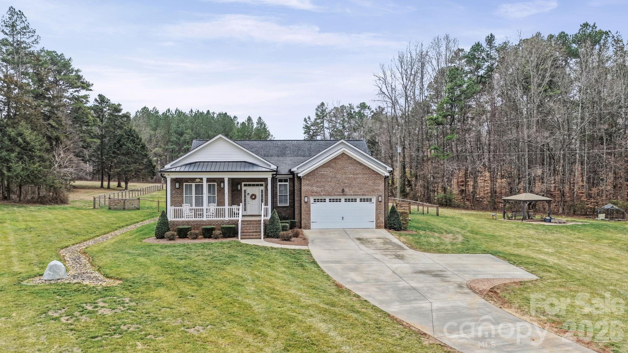 Welcome to peaceful country living on over 4 beautiful acres! This stunning home offers the perfect blend of charm, functionality, and space—inside and out.
Relax on the inviting rocking chair front porch or entertain with ease on the massive covered back patio, complete with ceiling fans and plenty of room for gatherings. The huge fenced backyard provides privacy, and space for your pets to roam, while the charming gazebo and fire pit overlook a stocked pond with fountain, creating your own private retreat.
Inside, you’ll love the open floorplan filled with natural light, real hardwood floors, elegant wainscoting, and tray ceilings that add architectural interest throughout. The spacious dining room features a walkout to the covered patio, making indoor-outdoor living seamless.
The kitchen is a showstopper with a huge island and breakfast bar, gas cooktop, wall oven and microwave, stainless appliances, stainless vent hood, and a dedicated coffee bar—perfect for hosting or everyday living.
The primary suite offers tray ceilings, private access to the covered patio, a tiled walk-in shower with seat, and a large walk-in closet with built-in shelving. Bedroom two includes its own attached bath with walk-in shower, while bedroom three features new LVP flooring.
Additional highlights include a dedicated office/study with pocket doors, a spacious drop zone at the garage entry, and a large laundry room with cabinets and counter space for folding.
If you’re looking for space, privacy, and thoughtful upgrades in a country setting, this one checks all the boxes.