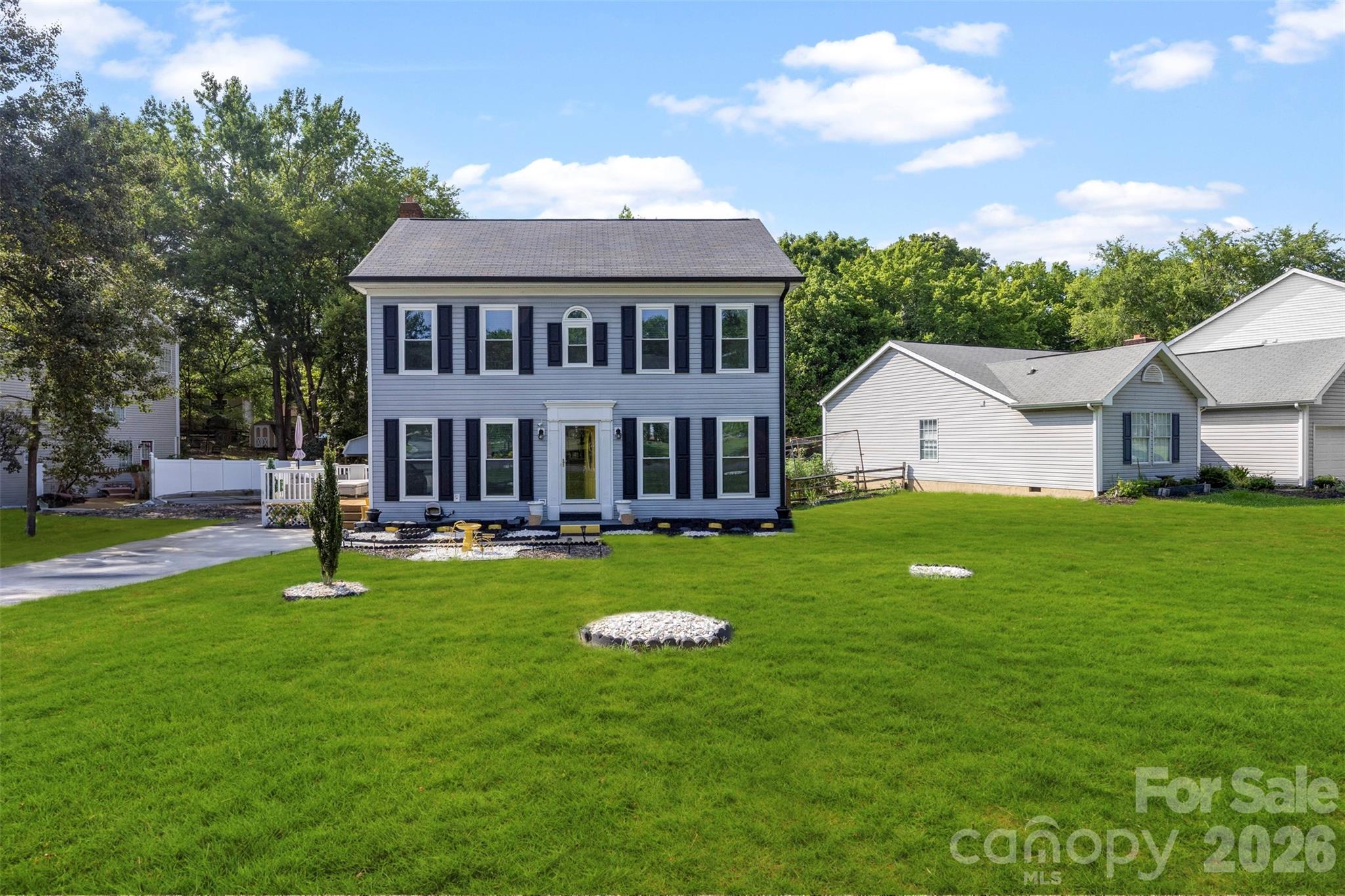 Welcome home to this charming two story Colonial tucked into a quiet, tree lined lot in the heart of University City! This 3 bedroom, 2 1/2 bath gem is full of character, from the updated kitchen with granite counters, stainless appliances, and a spacious island perfect for gathering, to the cozy living room with a fireplace ready for movie nights. Fresh flooring flows throughout the main level, and natural light pours in from every angle. Upstairs offers generous bedroom sizes and a primary retreat with its own private space to unwind. Step outside to your fenced backyard and discover a true bonus: a private, covered porch outbuilding complete with full electricity, a kitchenette, and its own bathroom! Perfect as a guest suite, income producing rental, in-law setup, home gym, or the ultimate she shed, the possibilities are endless. Minutes from UNC Charlotte, PNC Music Pavilion, Concord Mills, and easy access to major highways, this home puts you close to everything while still feeling tucked away. With summer in full swing, this is the perfect opportunity to plant roots before the new school year begins. Schedule your showing today!