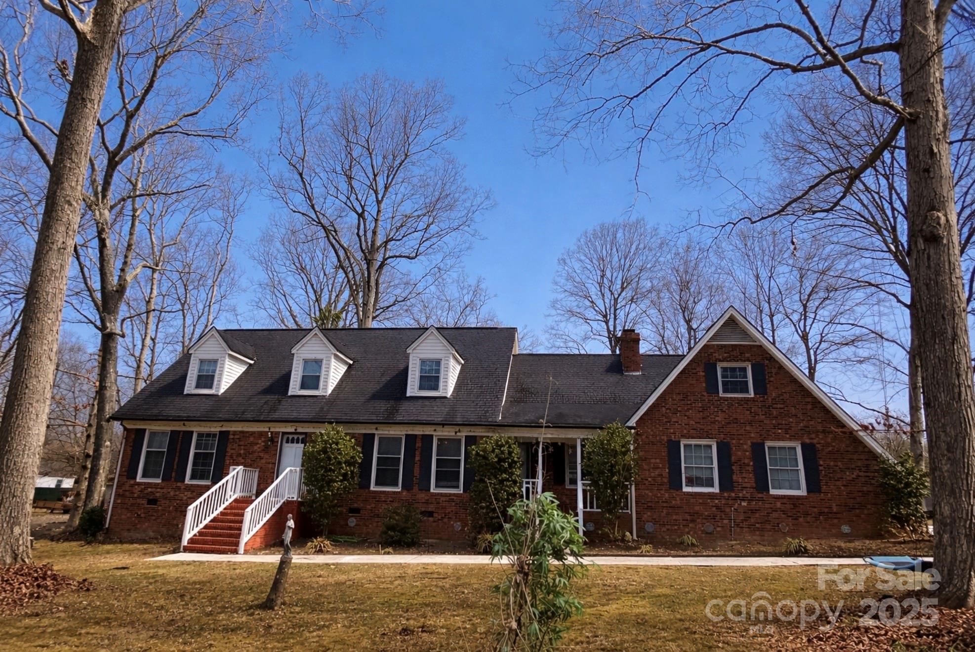 Spacious brick home on over half an acre with plenty of storage. Highlights include a beautiful wood beamed ceiling, stone fireplace, new carpet, and French doors leading to the outside patio. The primary bedroom features an on-suite bathroom and a private deck overlooking the large backyard. Two bonus rooms offer flexible space for an office or an extra bedroom—-or both!! Plenty of parking space including a 2-car garage with workshop area inside-all in an ideal location and conveniently close to town and schools. A MUST SEE!