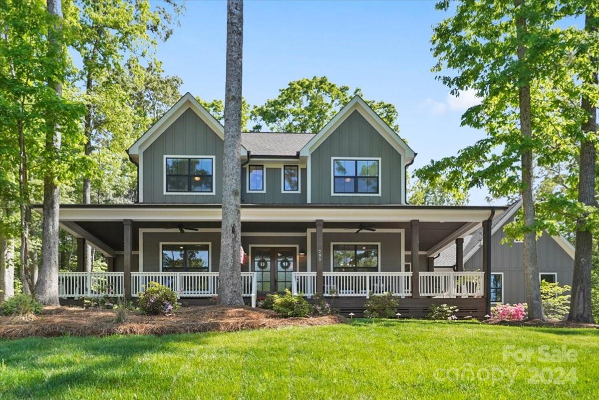 Modern Farmhouse on 1.29 acres within a gated community in Clover ISD.  When you walk through the front landscaped yard, you're greeted by a wrap around porch complete with ceiling fans.  Step into the double entry front door and you'll find an office and flex space to either side.  The main area features high ceilings with wood beams, a shiplap fireplace surround and flows into the gourmet kitchen complete with Z Line appliances quartz counter tops and white shaker cabinets.  Your inner chef will love the 6 burner gas stove with grill and double ovens.  The island has prep space & seating for 4.  Enjoy designer features & barn doors throughout the home. 
Hardwood flooring throughout main.   The primary on main features an attached screened in porch!  There are 3 carpeted bedrooms & 2 full baths upstairs. Feel like you're sitting in a treehouse as you relax on the screened back porch w/high ceilings and view of the landscaped yard w/firepit and seating. Laundry Room has porch access.