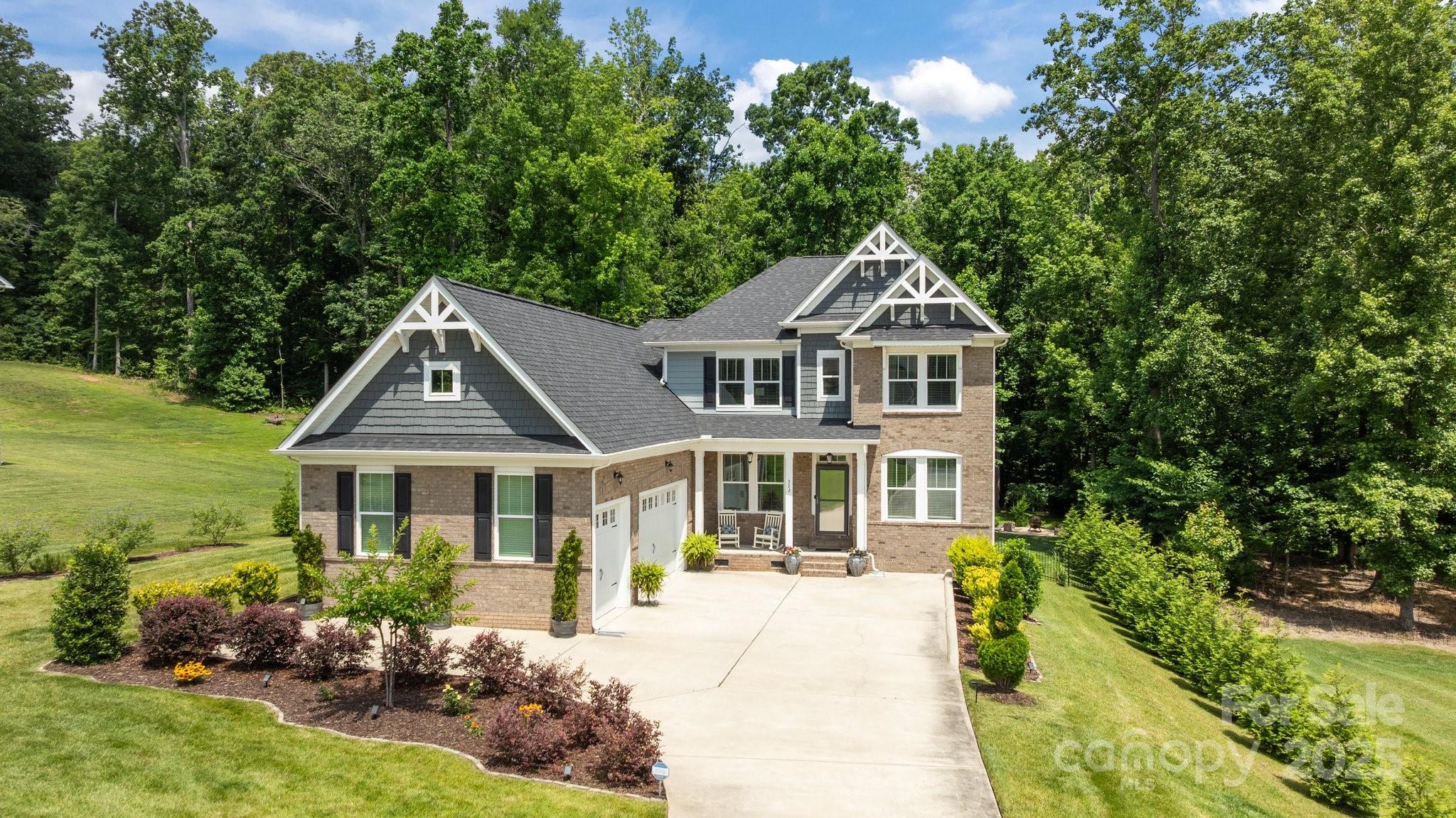 Welcome to 322 Ethan Lane, where modern living meets peaceful seclusion. Tucked away on a quiet street, this thoughtfully designed home offers a rare combination of style, comfort, and sustainability. Inside, you’ll find a bright, open floor plan that seamlessly connects the kitchen, dining, and living areas—perfect for everyday living or entertaining a crowd. Large windows frame picturesque views of surrounding nature, bringing the outdoors in and creating a sense of calm throughout the home. The spacious primary suite is a true retreat, complete with a custom walk-in shower, a generous closet, and convenient access to the laundry room. Outside, the backyard is a private oasis—serene, quiet, and surrounded by trees for year-round privacy. Utility bills stay low with a paid-off solar system, private well, and battery backup for peace of mind. Whether you’re sipping coffee on the patio or enjoying the low-maintenance lifestyle, this home checks all the boxes. Don't wait!