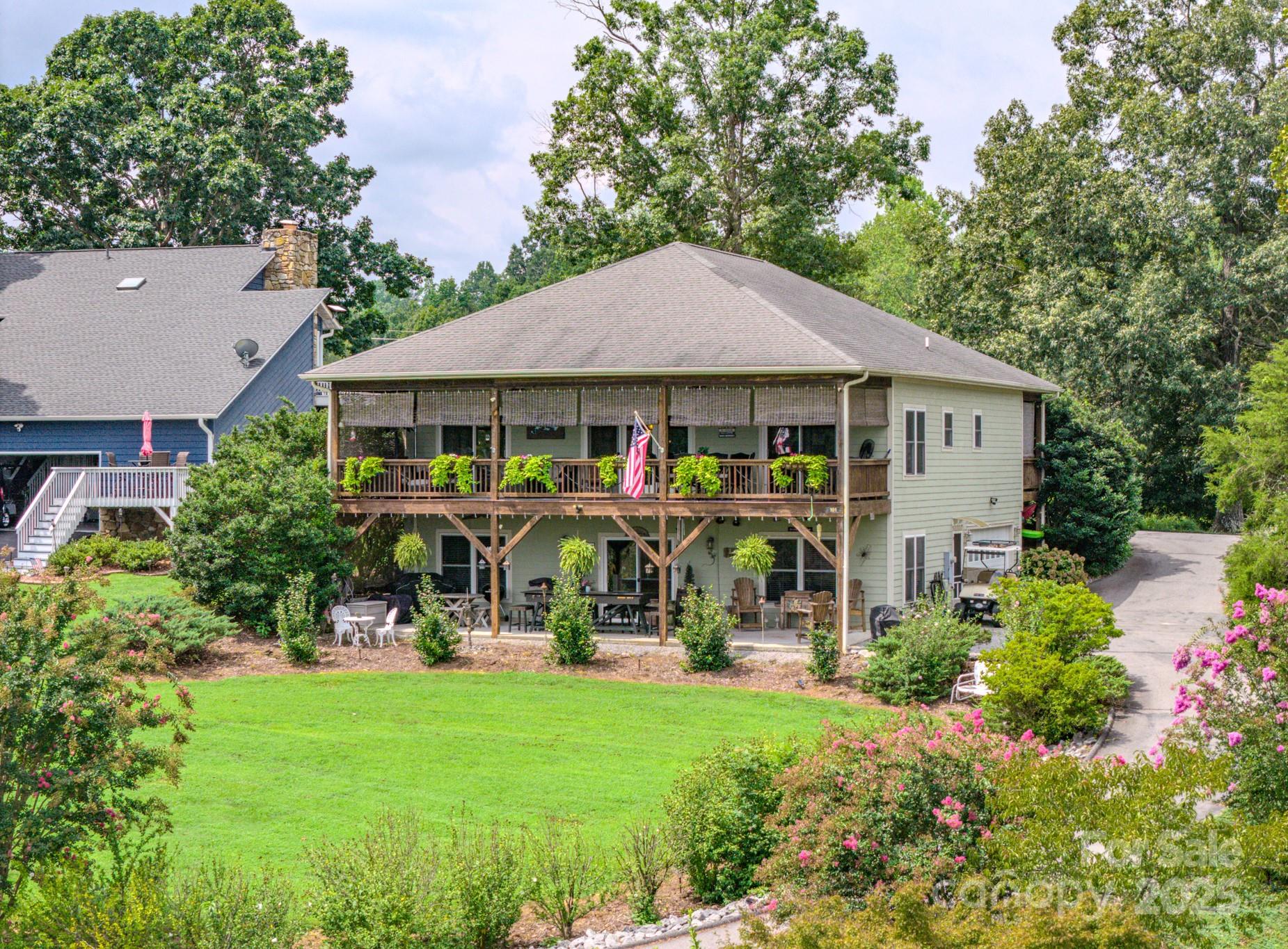 Big Open Water Views from 1280 square feet of Covered Deck, as well as Living Room, Bedroom and Kitchen. One of Lake James best water view homes and also on Marion Lake Club Golf Course. End of the street living with Members Boat Slip option, just a couple hundred yards away for easy/convenient access to the water from the Lake Club Members Marina. Enjoy year round water views of one of the cleanest Lakes in North Carolina with a beautiful, well maintained Mountain Golf Course in your front yard. Live your best life of  natural beauty, water activities and outdoor paradise  in this 3 bedroom/3 bath home with oversized garage large enough for a workshop and parking. Open floorplan allows for abundant natural light and great views throughout the home. Well landscaped property offers elevated views to the Lake with gently slopping access to the water. Outdoor living space provides year round enjoyment of sunrises and beautiful moonscapes glistening on Lake James. Mountain Lake Living at its best! Recently connected to County Water system. Features also include new Hot Water heater in 2025, new smart garage door opener as well as new front loading washer and dryer in 2026! Brand new roof in June of 2026!