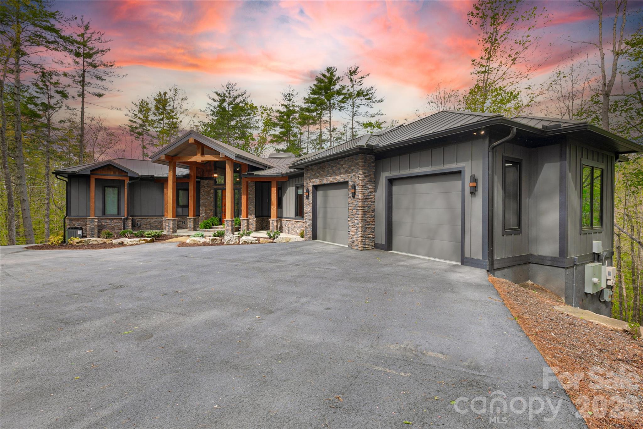 Perched high above it all on 6.4 secluded acres, this extraordinary mountain estate captures the essence of refined privacy and modern elegance. Thoughtfully crafted with impeccable attention to detail, the home offers a seamless blend of sophistication, scale, and serenity. 
Inside, soaring ceilings and expansive living spaces create a striking yet inviting atmosphere anchored by multiple fireplaces that bring warmth and ambiance throughout.  At the heart of the home, the chef's gourmet kitchen is both stunning and functional. Featuring rich leathered granite, high end appliances, and an abundance of counter space designed for serious culinary pursuits. Dual pot fillers over the gas cooktop elevate convenience, while subtle under cabinets floor lighting adds a soft, luxurious glow. The screened porch with a wood burning fireplace extends the living experience outdoors, creating the perfect setting for year round entertaining. The primary suite is a true sanctuary showcasing dramatic ceiling lines with wood beams. Spa inspired bath with a double sided, multi head shower designed for total indulgence.  Guest bedroom on the main level, located on the opposite side of the primary suite, offers exceptional privacy features its own ensuite.  The lower level is a destination of its own, featuring a fireplace, complete with a custom wood built in bar, live edge bar top, billiards room and expansive entertainment space. Two additional bedrooms with spacious spa bathroom complete with double sinks and a soaking tub. Generous storage room with dehumidifier. Outdoor living is equally compelling, with curated entertainment area and a private hot tub designed for evenings under the stars.  Designed for both comfort and reliability the home is equipped with solar power system that provides clean, efficient energy. In the event of a power outage, the system continues to generate electricity, helping keep the home powered much like a built in backup generator for added peace of mind. Offering efficiency and peace of mind. An integrated indoor outdoor sound system allows music to flow effortlessly throughout the home and exterior living space enhancing every gathering. 
A rare offering where elevated design, advanced features, and mountain tranquility converge.