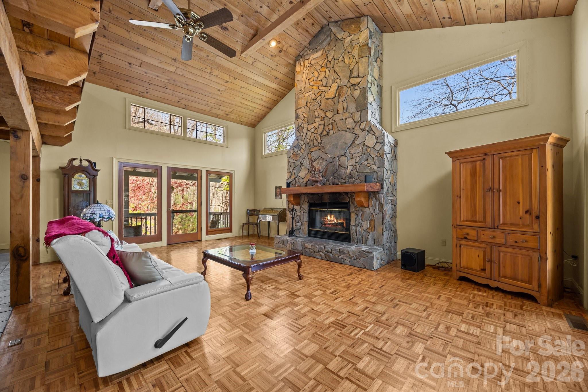 Private Mountain Sanctuary nestled within 700 acres of preserved natural beauty! This magnificent 3-bedroom + loft, 3-bath home features soaring cathedral ceilings accented by warm hardwoods and rustic beams throughout. The gourmet kitchen is designed to impress with custom cabinetry and shelving, a gas range, abundant storage, and exceptional functionality for everyday living or entertaining. Gather around the massive wood-burning rock fireplace and enjoy the cozy mountain ambiance, or take in lovely winter views of Flat Top Mountain surrounded by lush native flora. The thoughtfully designed open floor plan offers the perfect setting for family gatherings, entertaining guests, or simply relaxing in your own peaceful retreat. Sip your morning coffee from one of several covered porches while listening to birdsong and watching deer and squirrels pass through the property. Flexible living options allow you to choose your preferred primary suite level, and all spacious bedrooms feature ensuite baths for ultimate comfort and privacy. Whether you need space for hobbies, crafts, a home office, or creative pursuits, this home offers room for it all. Additional highlights include SKYRUNNER fiber optic internet, a Generac propane generator, and a double-car garage. Solidly built and designed to embrace the beauty of mountain living, this exceptional property combines privacy, comfort, and convenience in one remarkable location. You truly won’t find a more convenient mountain retreat!