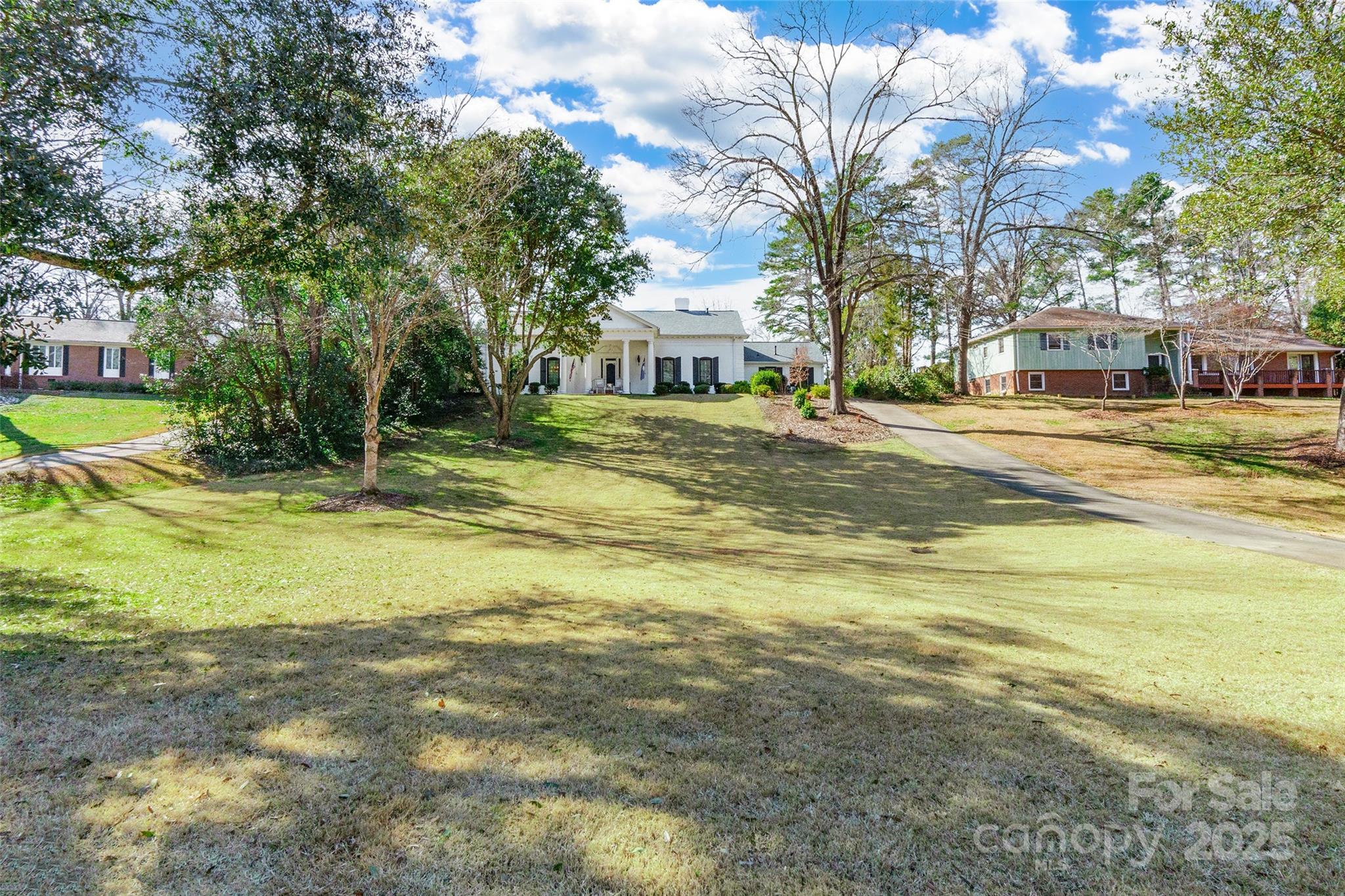 This stunning 4 BD, 3.5 BA home seamlessly blends timeless charm with modern updates. A covered front porch invites you into a home featuring refinished hardwood floors throughout. The renovated kitchen, while retaining some original details, showcases quartz countertops, a farmhouse sink, a gorgeous backsplash, a coffee/wine bar with a beverage refrigerator, and a window overlooking the screened porch. Enjoy 2 fireplaces—one in the den & another in the living room. The main-level primary bedroom boasts a show-stopping bathroom with an oversized shower with dual shower heads, a clawfoot tub & marble floors. Upstairs, you'll find 3 spacious bedrooms—one with a dedicated full bathroom and two connected by a Jack & Jill bath. Plantation shutters, newer HVAC units, and an encapsulated crawl space add comfort & efficiency. The backyard is a dream, featuring a screened porch, paver patio, firepit, fenced pool and a covered poolside lounge with electrical hookups. Get ready to fall in love!