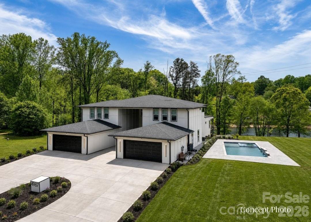 Stunning modern lakefront home perfectly positioned on a peaceful cove with 1100' of shoreline on Lake Norman, offering expansive water views and a large private lot. This thoughtfully designed residence features bright, open-concept living spaces with soaring ceilings, a statement fireplace, and seamless flow into a sleek, oversized kitchen with a large island—ideal for entertaining. The home includes multiple spacious bedrooms, many with private ensuites, including a luxurious primary suite with a spa-like bath, freestanding soaking tub, walk-in shower, and a custom closet with built-ins and in-closet laundry. Additional highlights include a stylish dining area, dedicated office, flex spaces, a music room, and a private theater. Enjoy outdoor living year-round with a covered patio, expansive balcony with water views, and a large backyard leading to the waterfront. The unfinished basement offers endless potential for customization, while the outdoor pool and spa area is ready for your dream backyard retreat. This exceptional property combines modern design, functional living, and a prime lakefront setting. This home is a true MUST SEE! **Short term rentals are allowed**